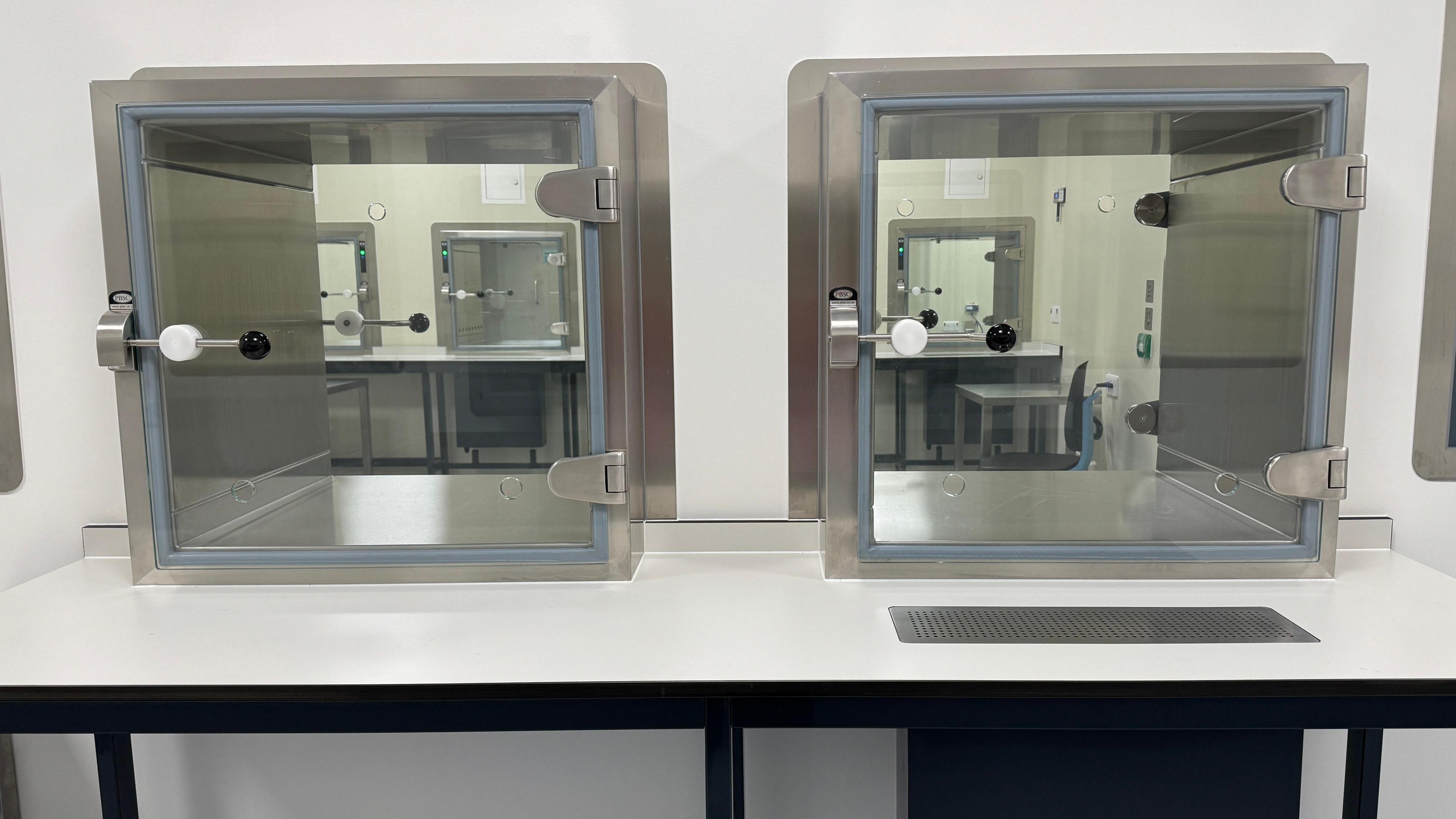 An interior shot of the Cambridge Cellular Therapy Lab, containing steel containers with glass doors.