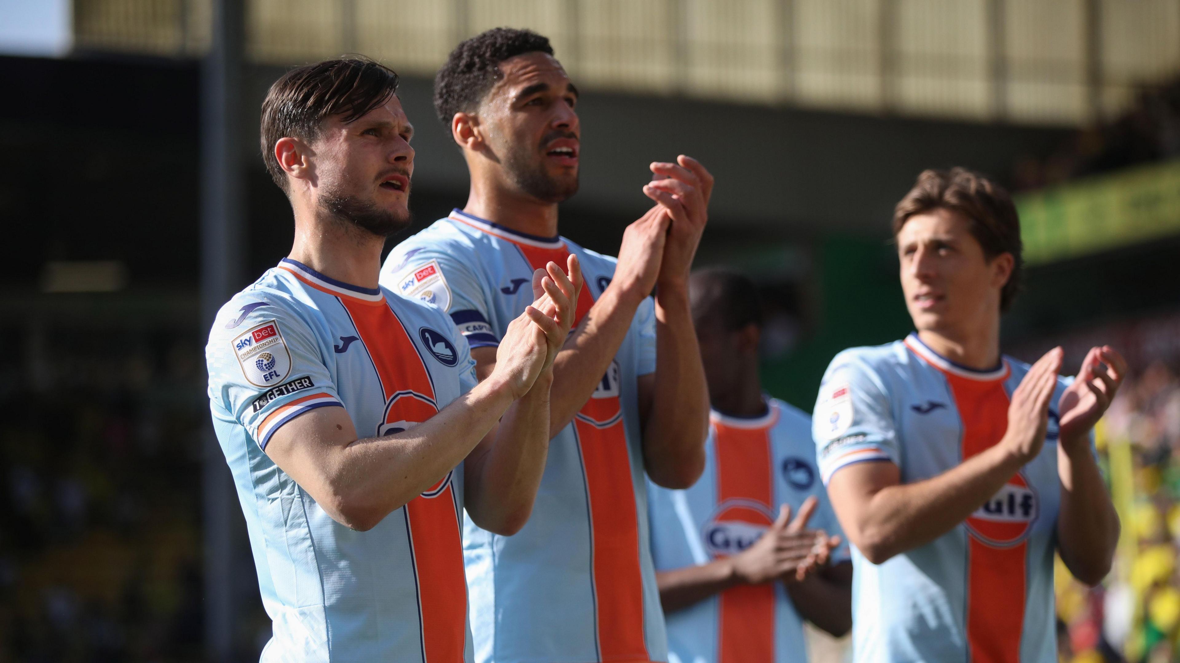 Liam Cullen, Ben Cabango and Goncalo Franco clap Swansea's fans at Norwich 