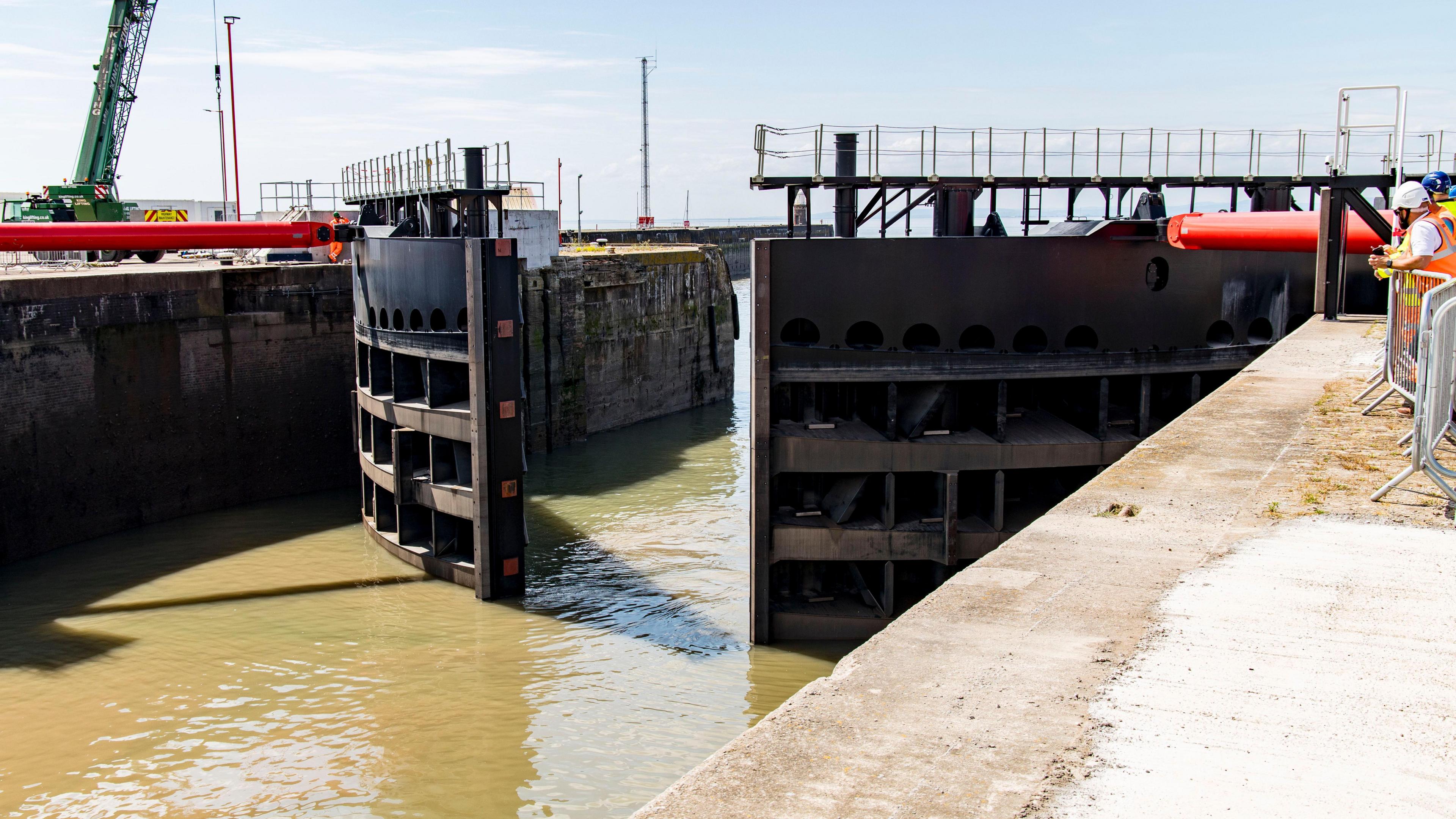 The new flood gates at Avonmouth Port. They are half open and water is flowing through.