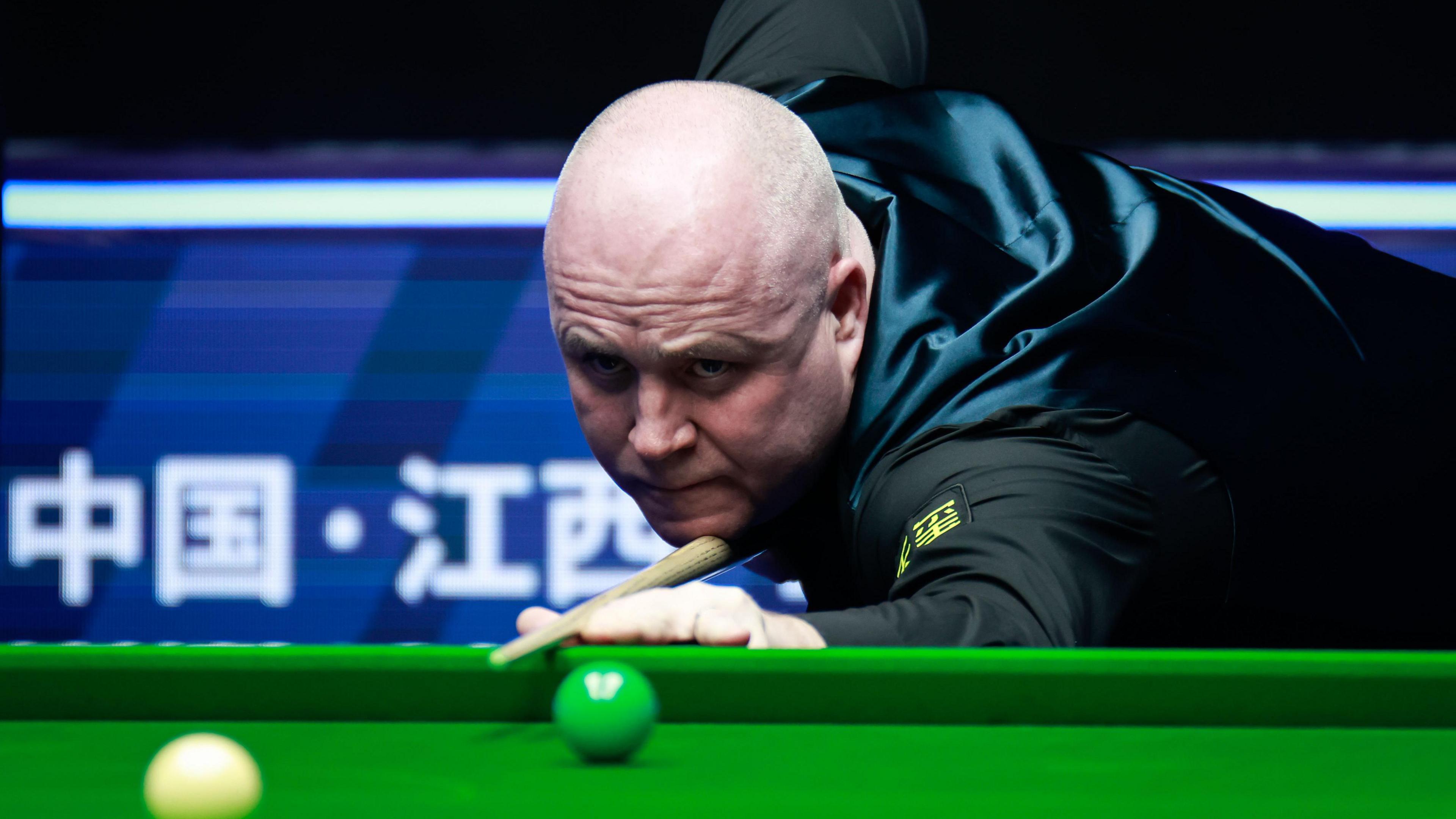 John Higgins focuses on a shot