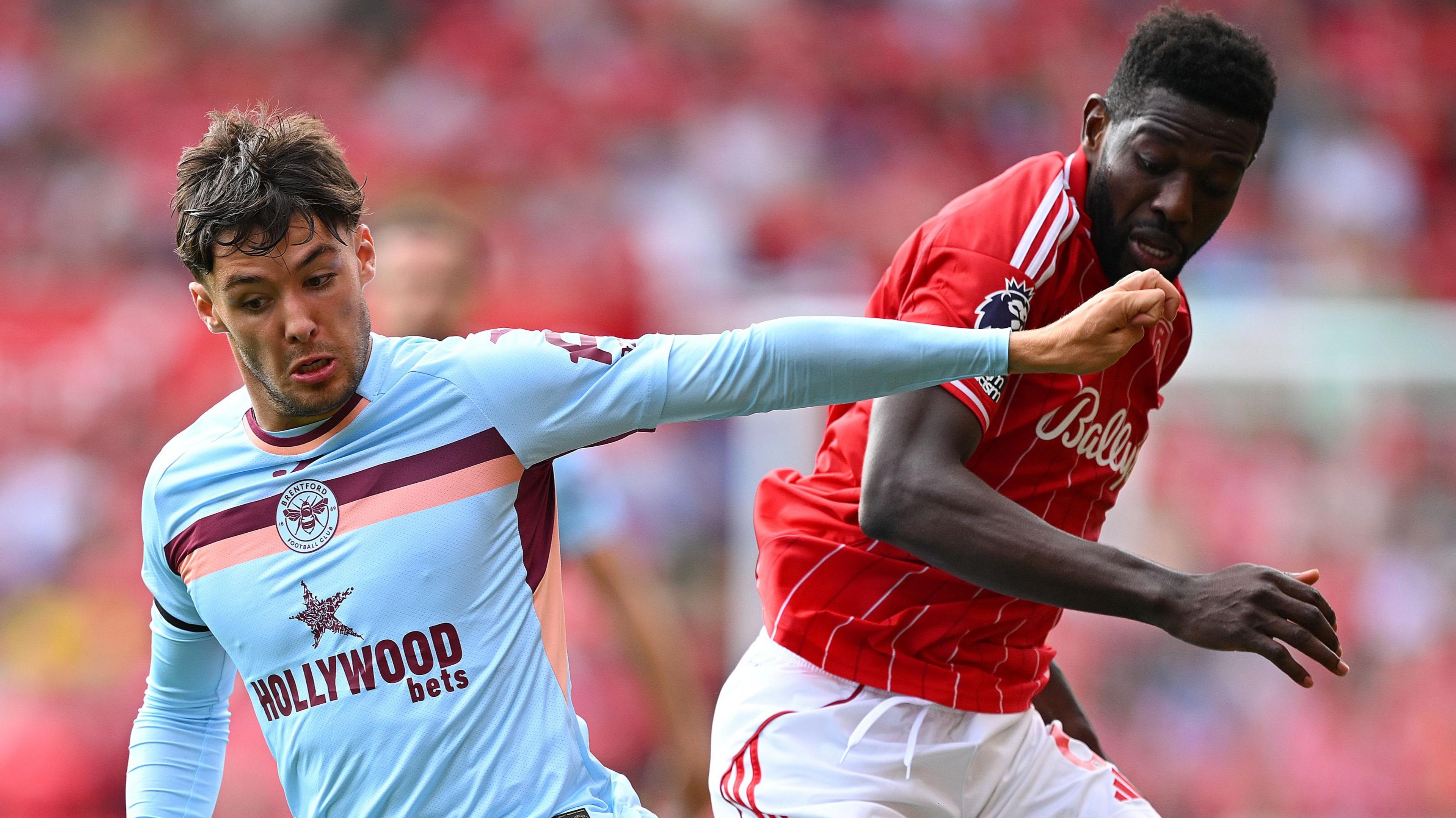 Aaron Hickey battles for possession