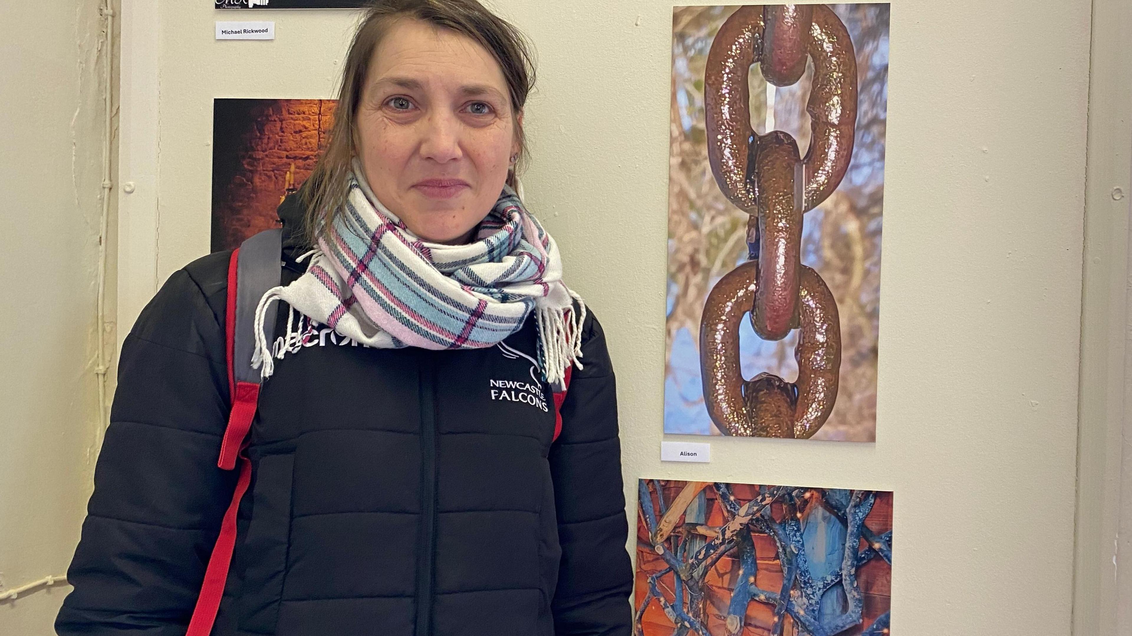 Alison Murray, who is visually impaired, in front of one of her photographs