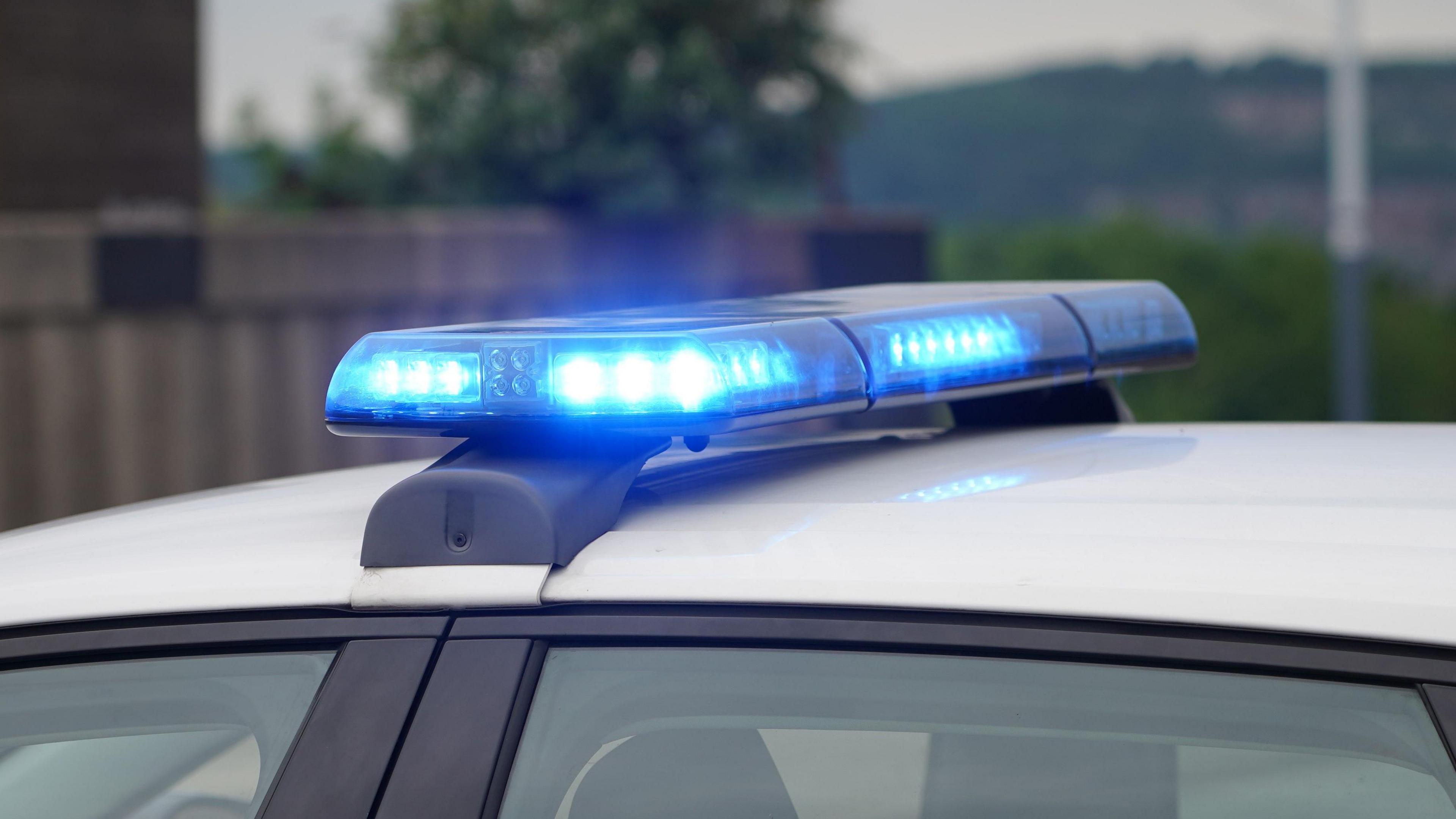 Close-up of blue light on top of a police car 