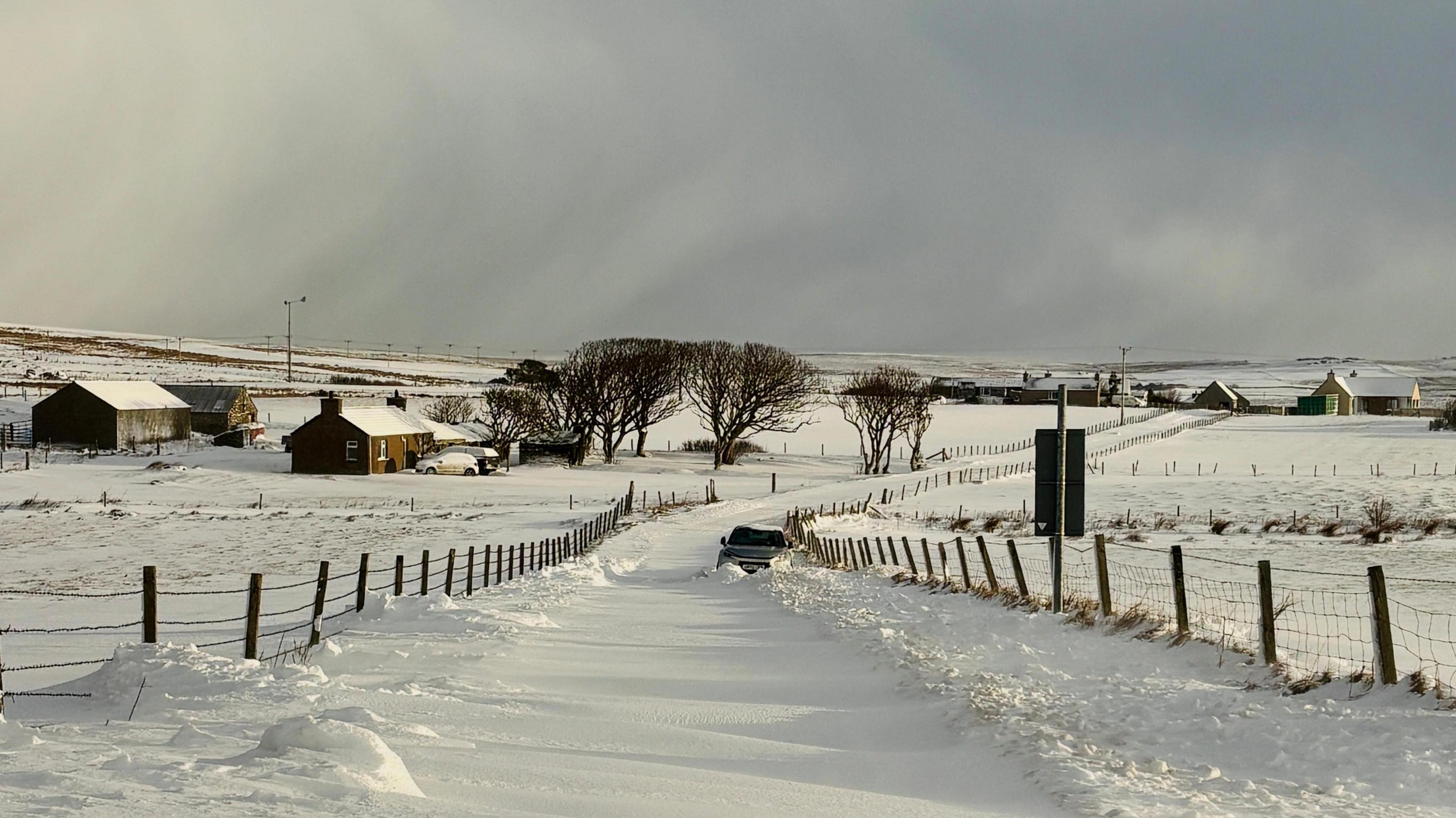 Car snowed in on a country road 