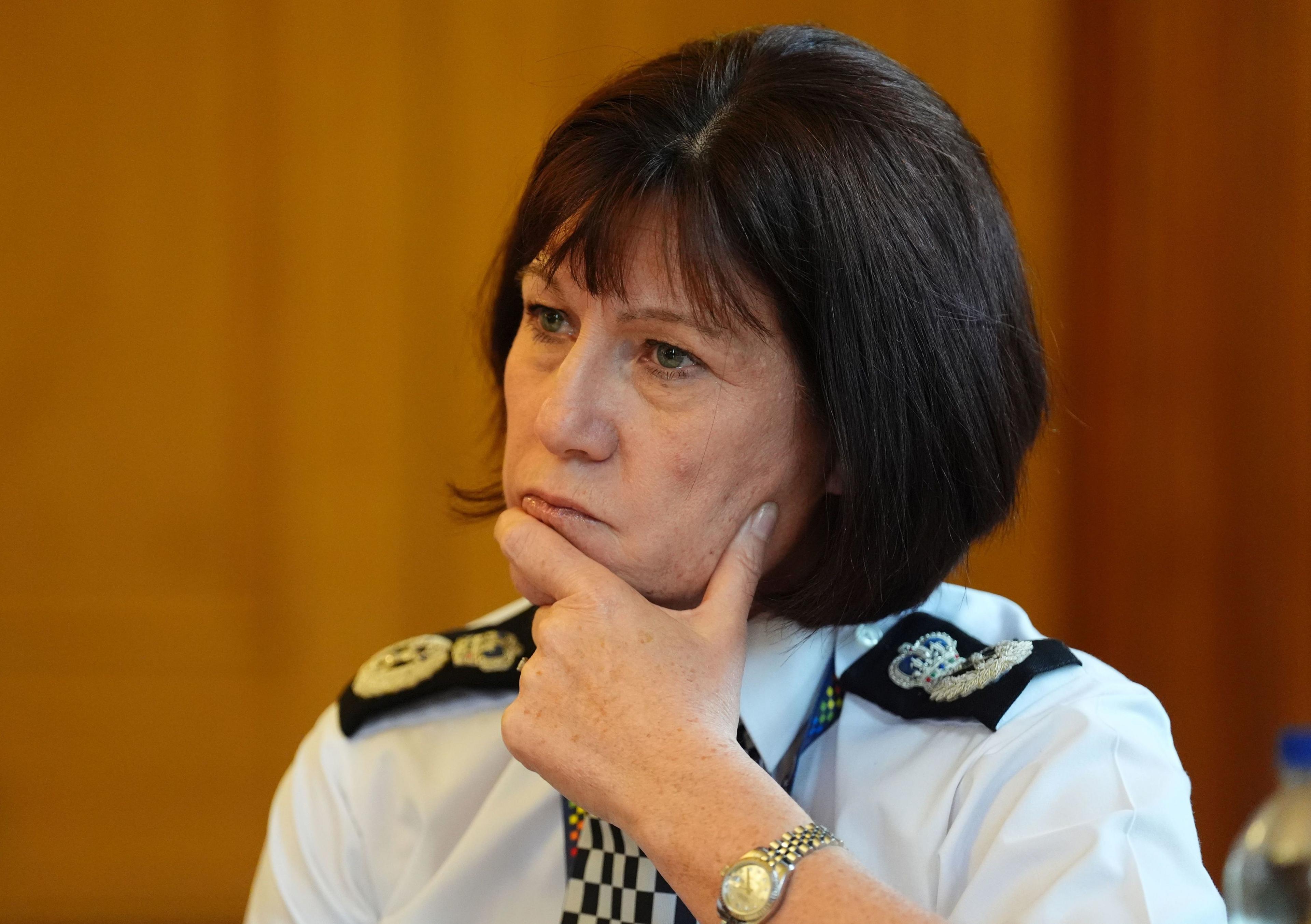 Jo Farrell in her chief constable's uniform with her hand on her chin