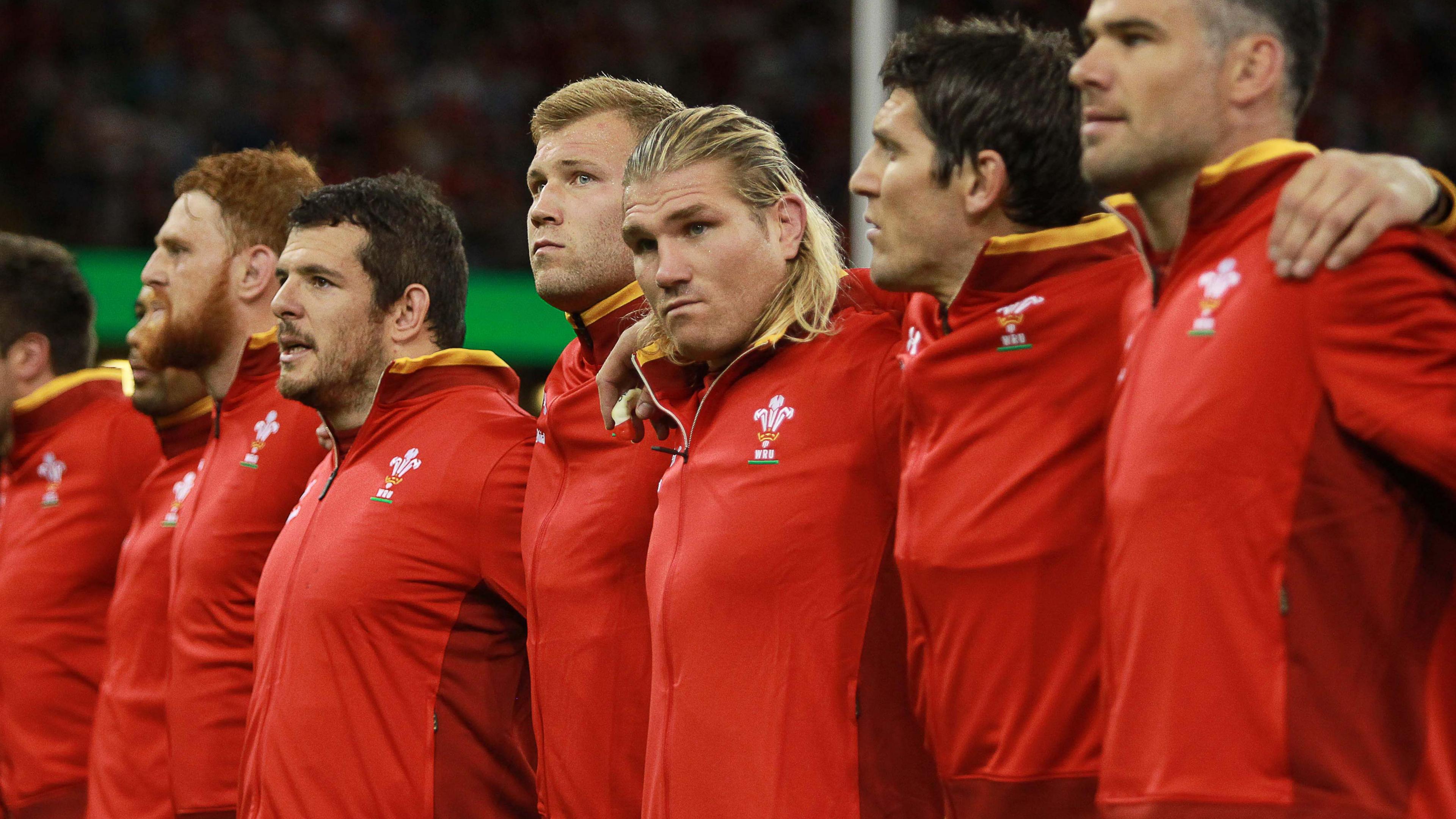 Wales hooker Richard Hibbard lines up with teammates before the national anthem
