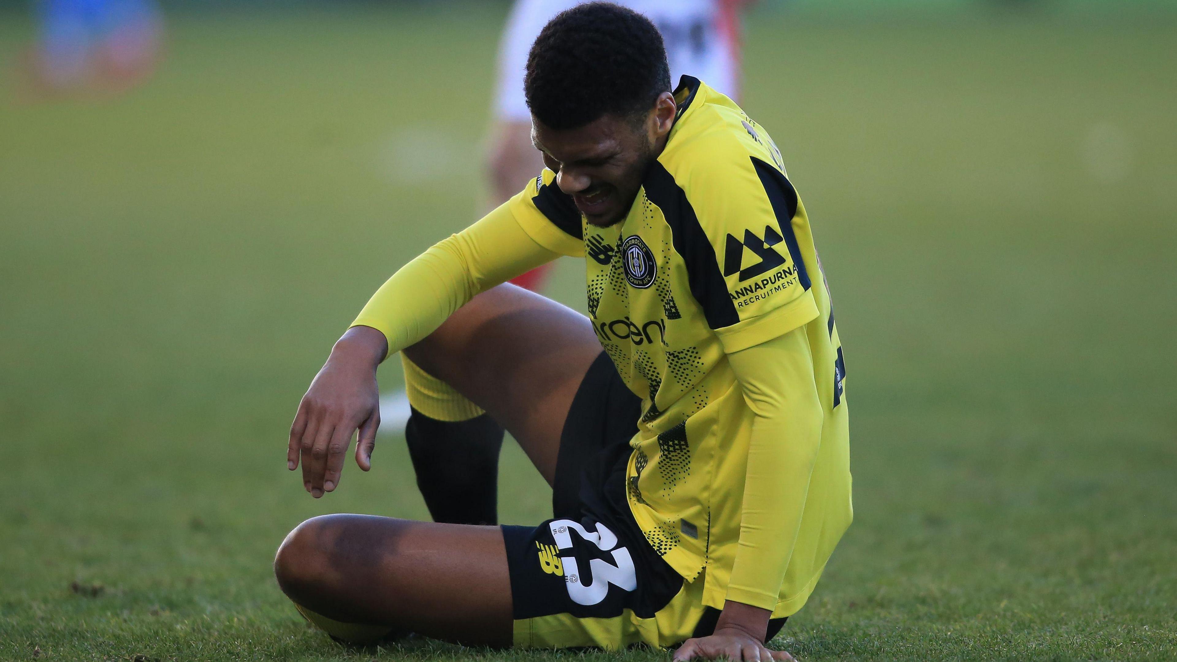 Harrogate Town's Kyle Jameson looks dejected while on the ground during a League Two match