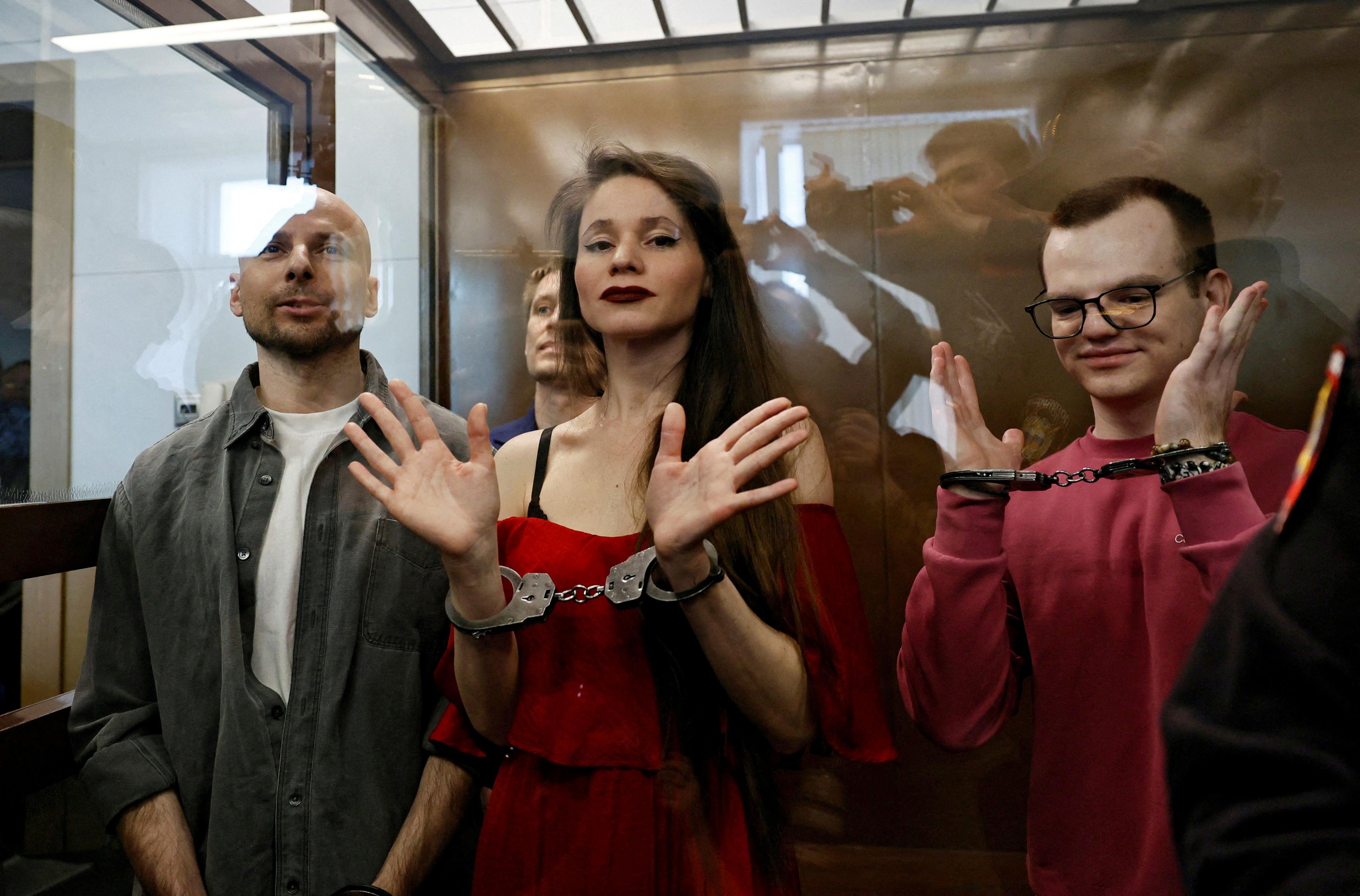 Antonina Favorskaya, Konstantin Gabov, Sergey Karelin and Artyom Kriger  are handcuffed and standing in the dock during their trial. 