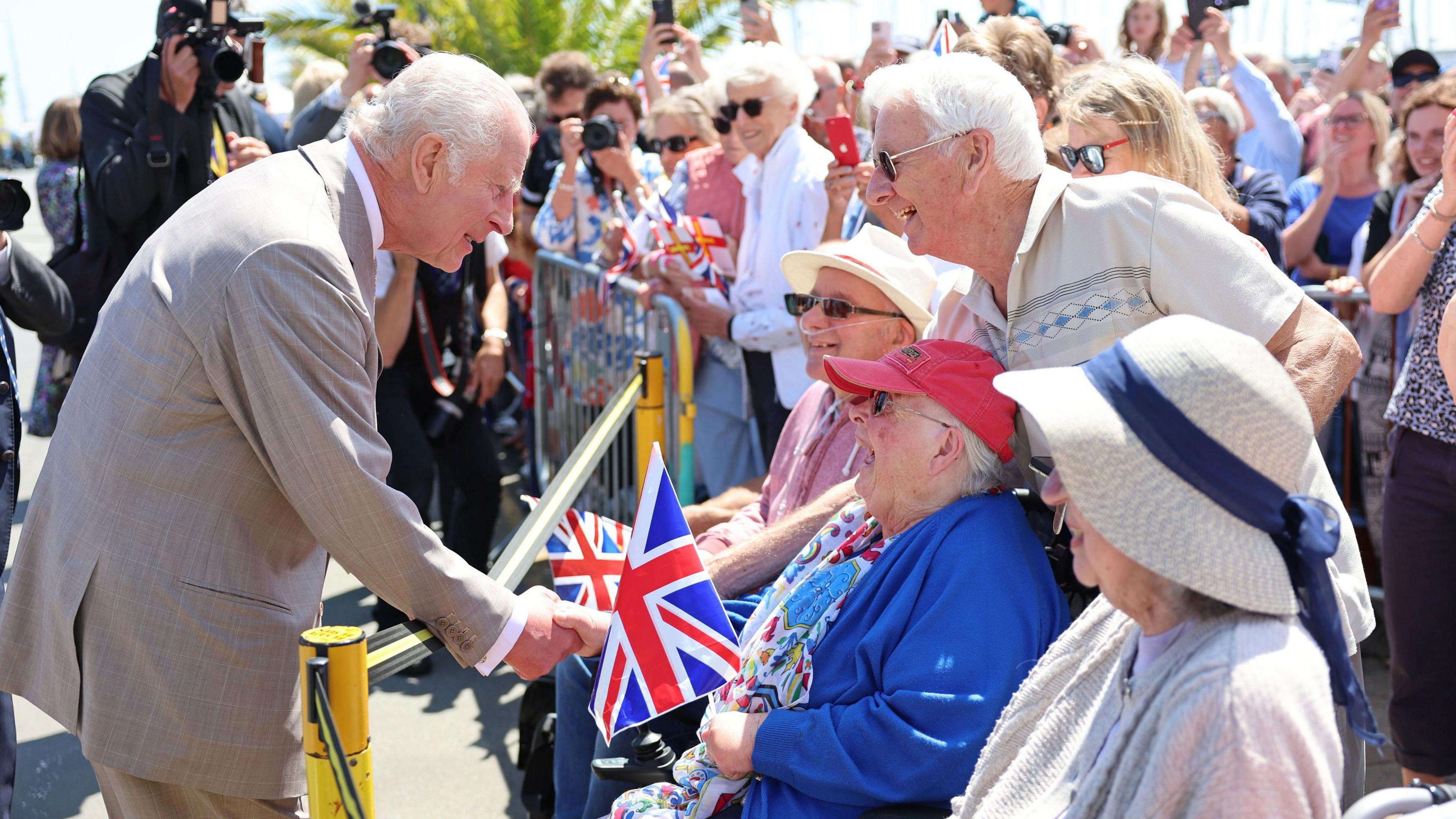 King Charles III meeting well-wishers as he arrives to attend the special sitting of the States of Deliberation, at the Guernsey Parliament in Saint Peter Port, Guernsey.