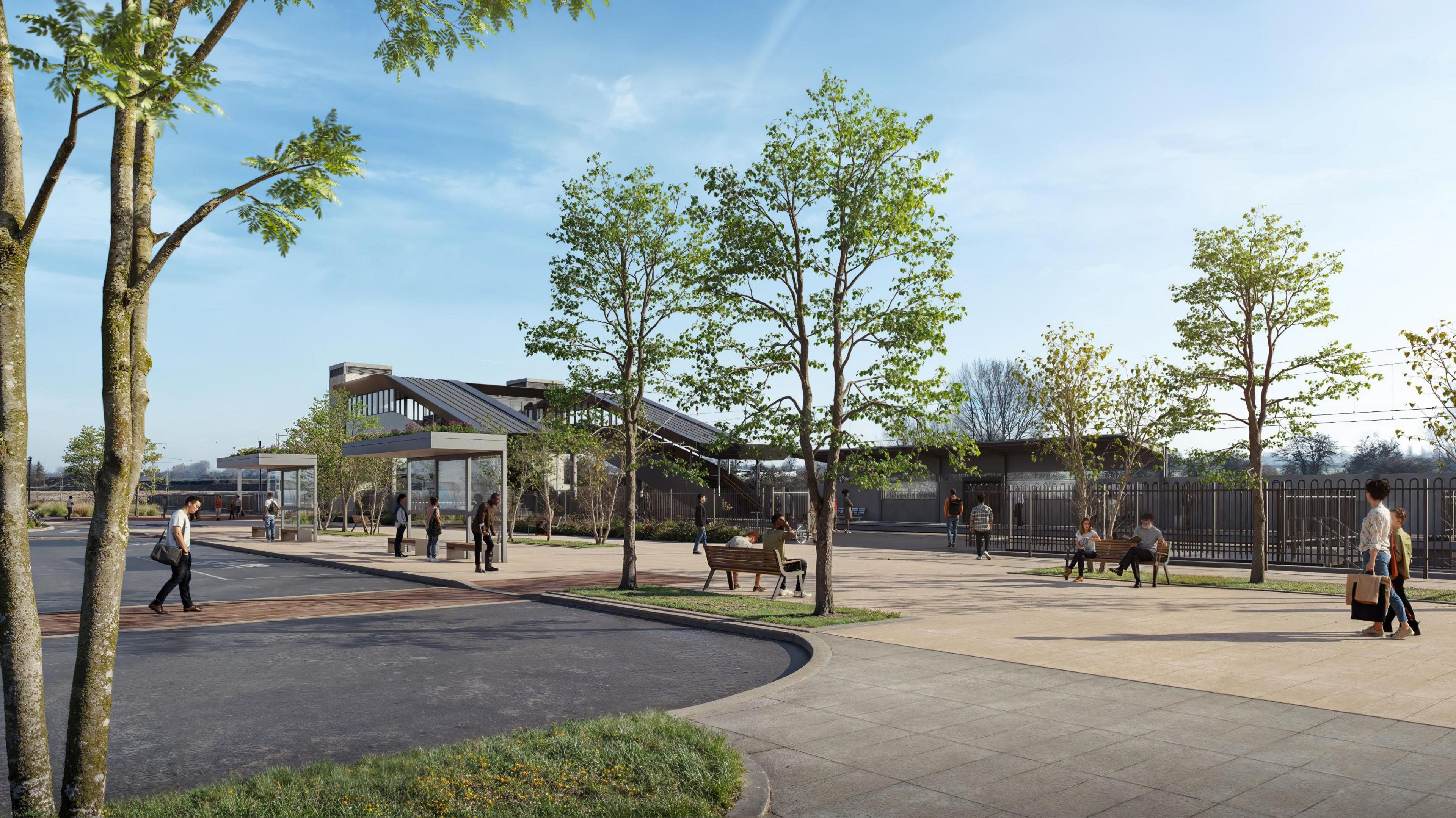 An artists impression of the outside of a train station. There is a bridge over the tracks and metal fences in front of them. In front of that are a number of trees, benches, bus stops and people walking about. 