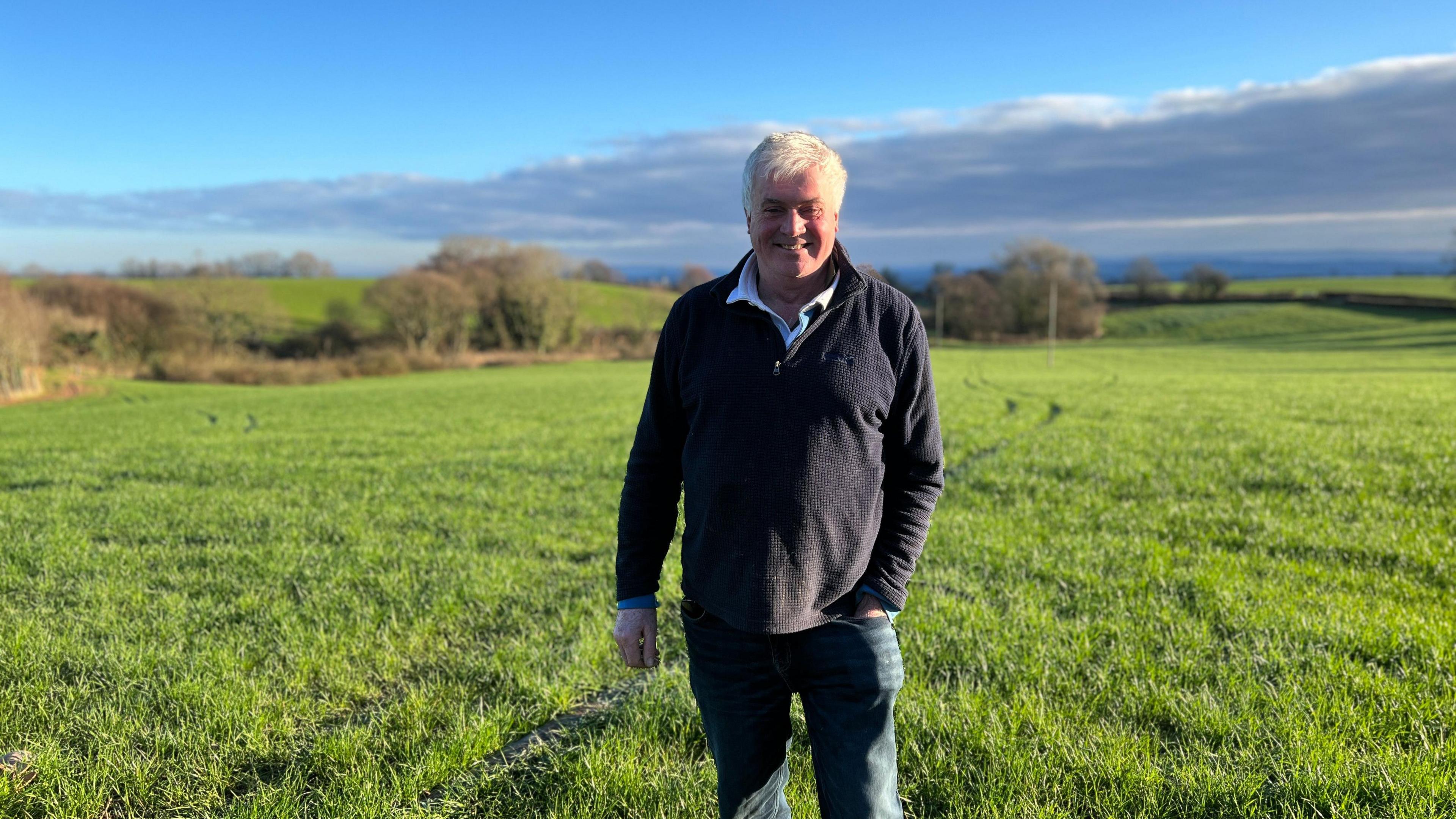 farmer standing in a lovely green field