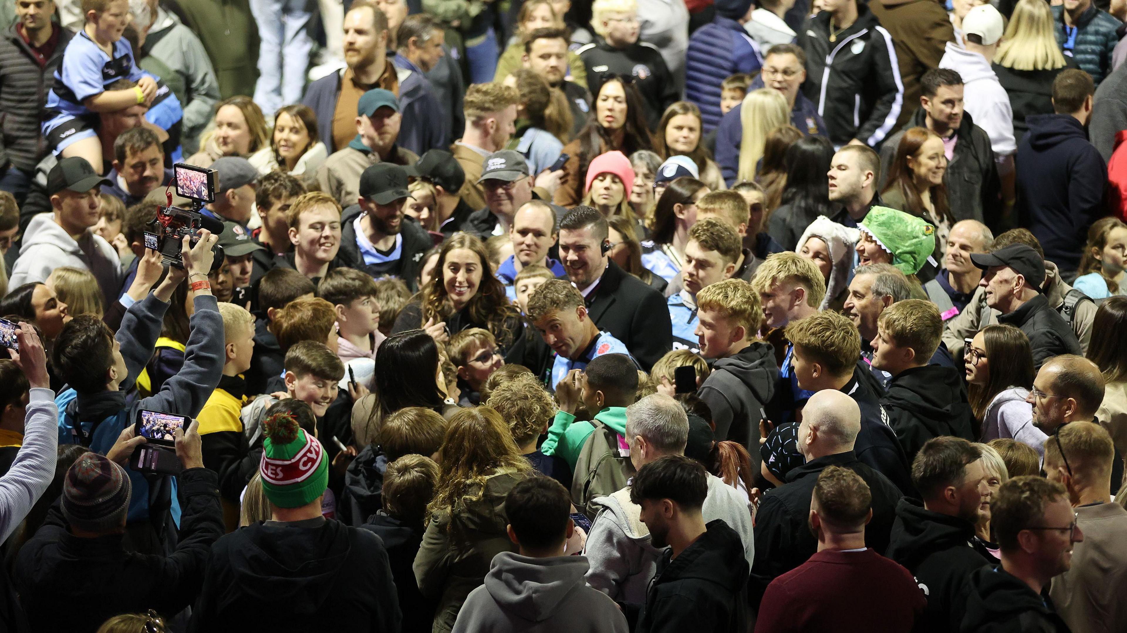 Cardiff fans flock onto the pitch after the game