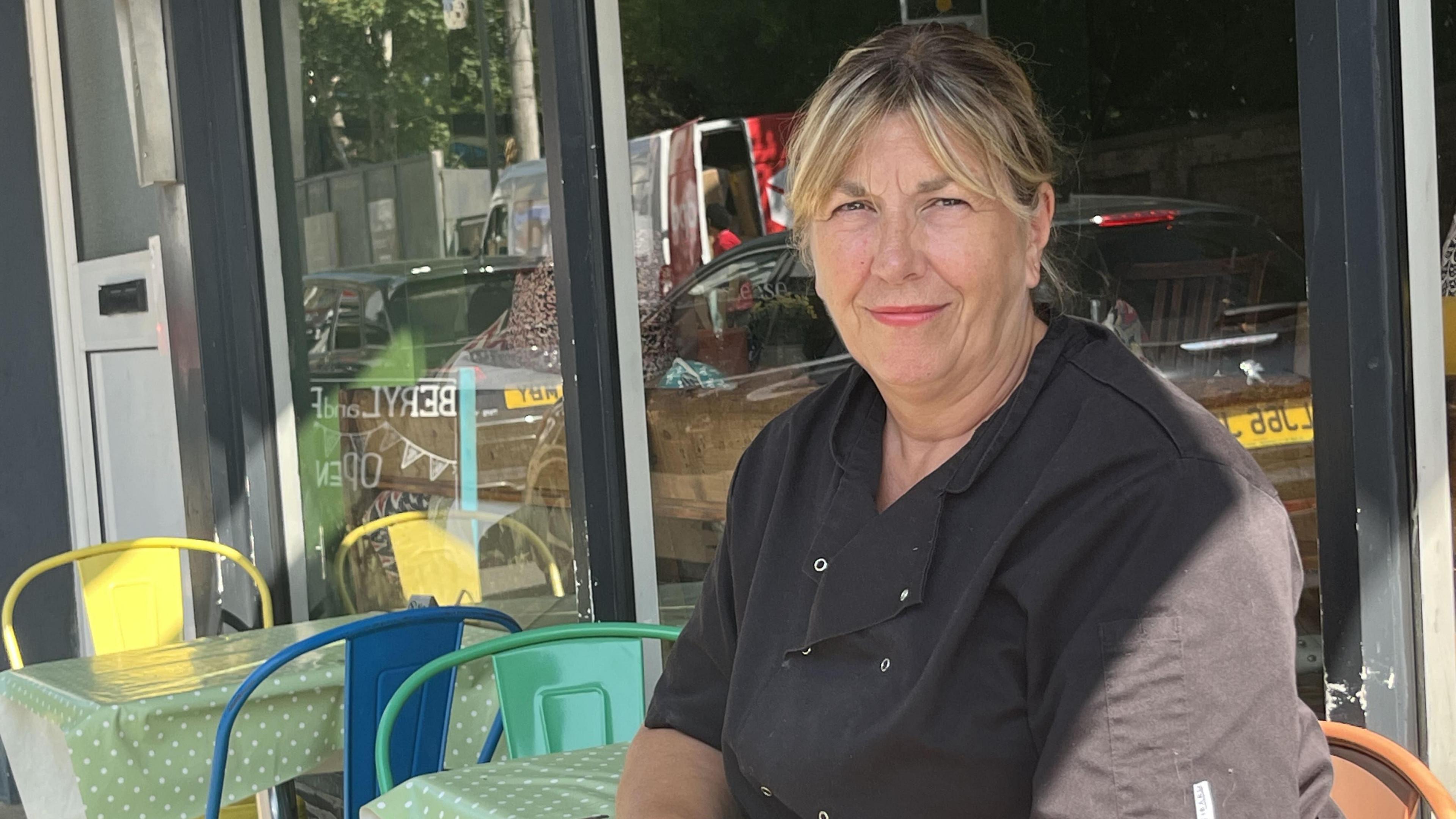 Close up image of cafe owner Debbie Davis sat outside her cafe in Reigate