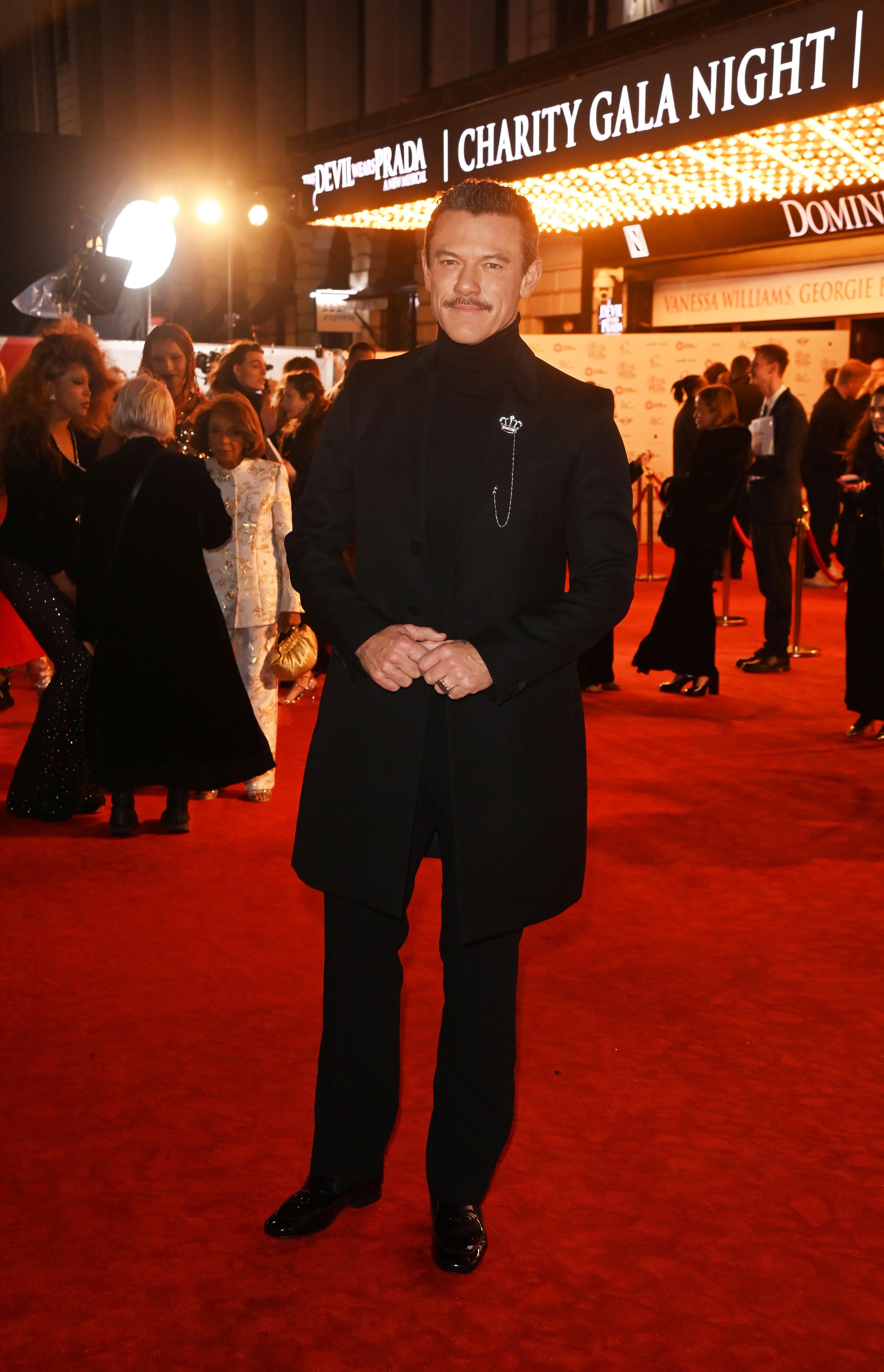 Luke Evans wears all black on Devil Wears Prada: The Musical red carpet