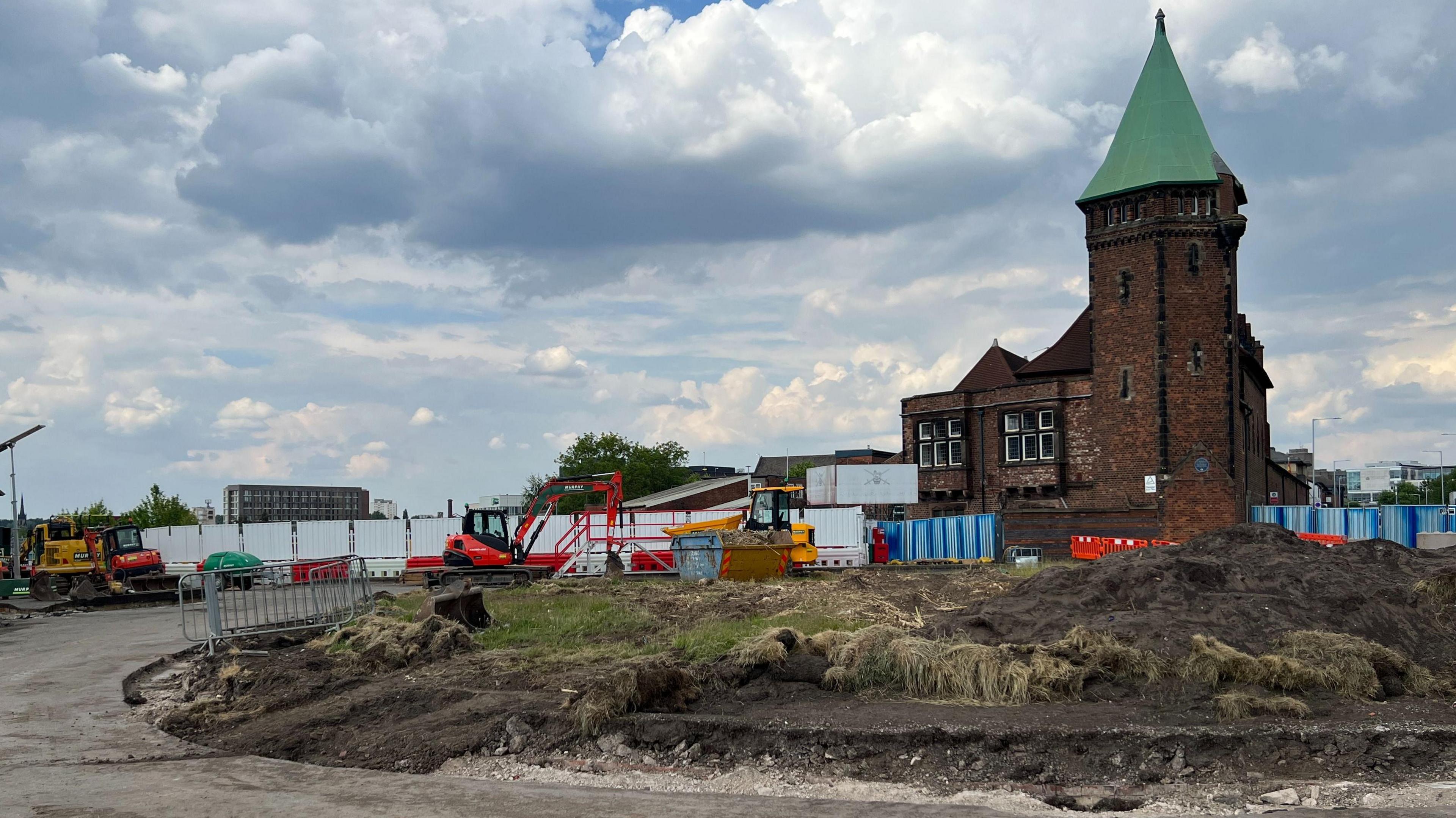 Turf can be seen dug from the roundabout centre with the tower of the army reserve centre in the background.