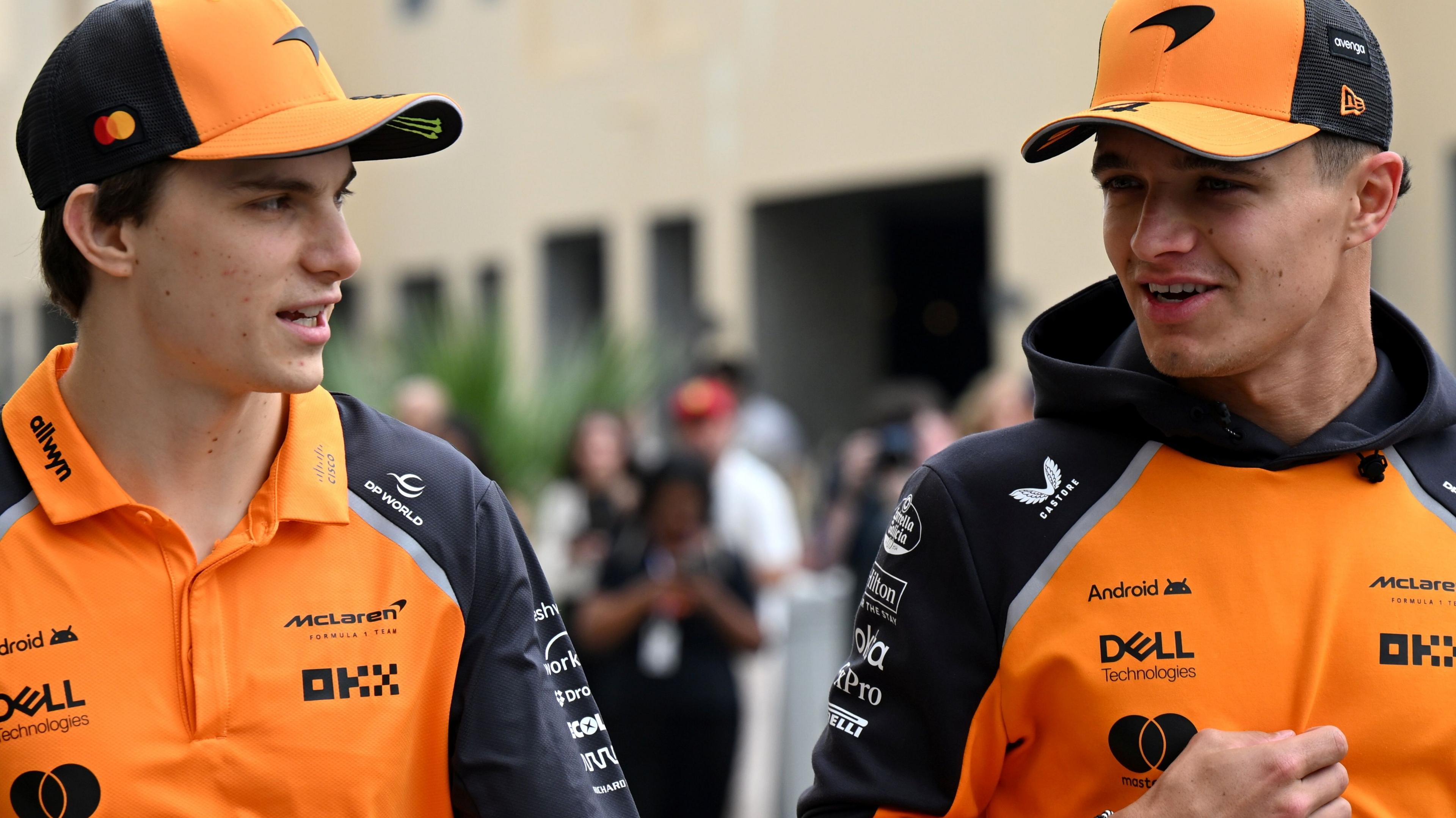 McLaren drivers Oscar Piastri and Lando Norris having a conversation as they arrive at the Abu Dhabi Grand Prix on Friday