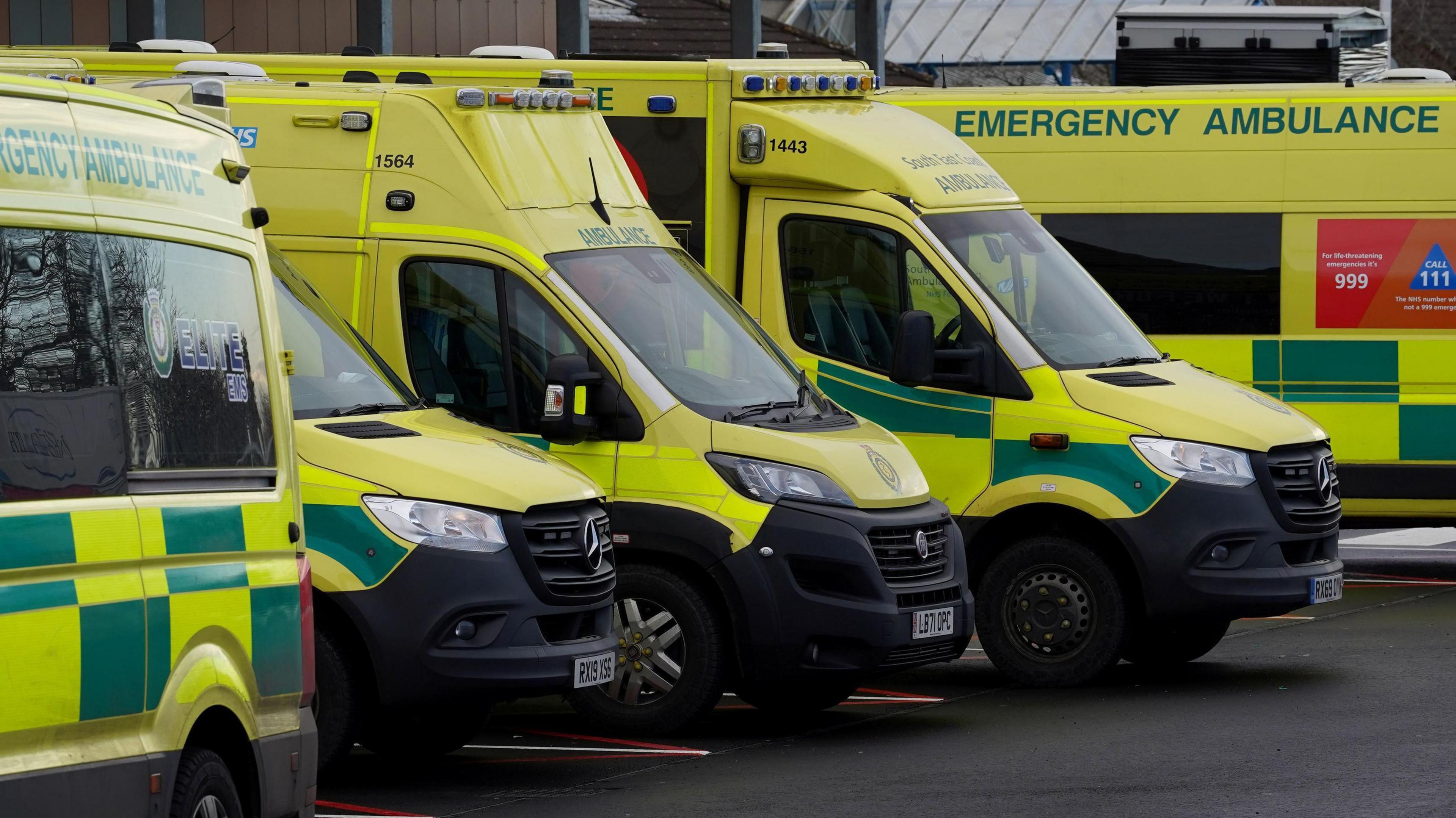 Ambulances wait outside the William Harvey Hospital