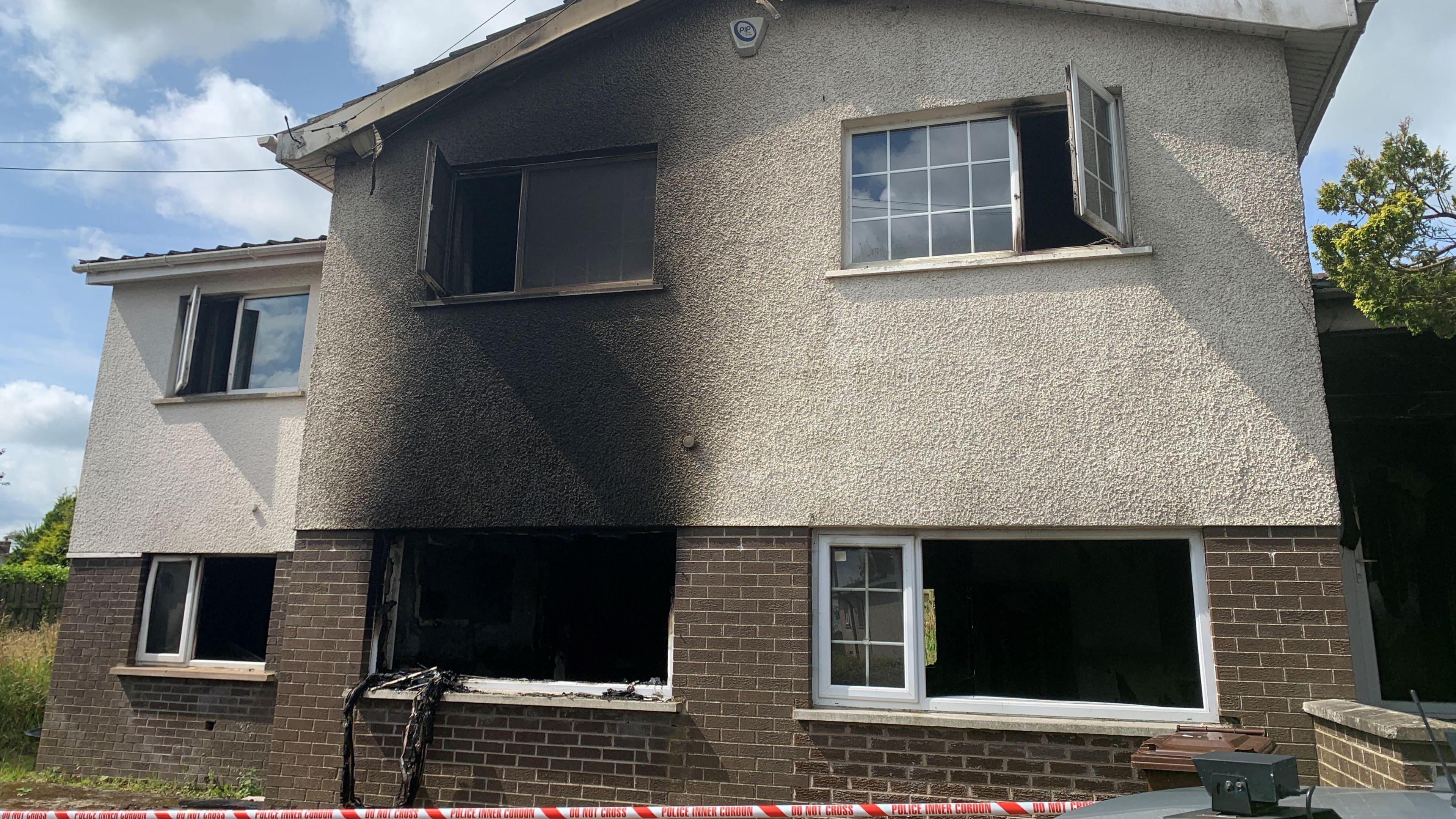 The house has clear fire damage to ground and first floor.