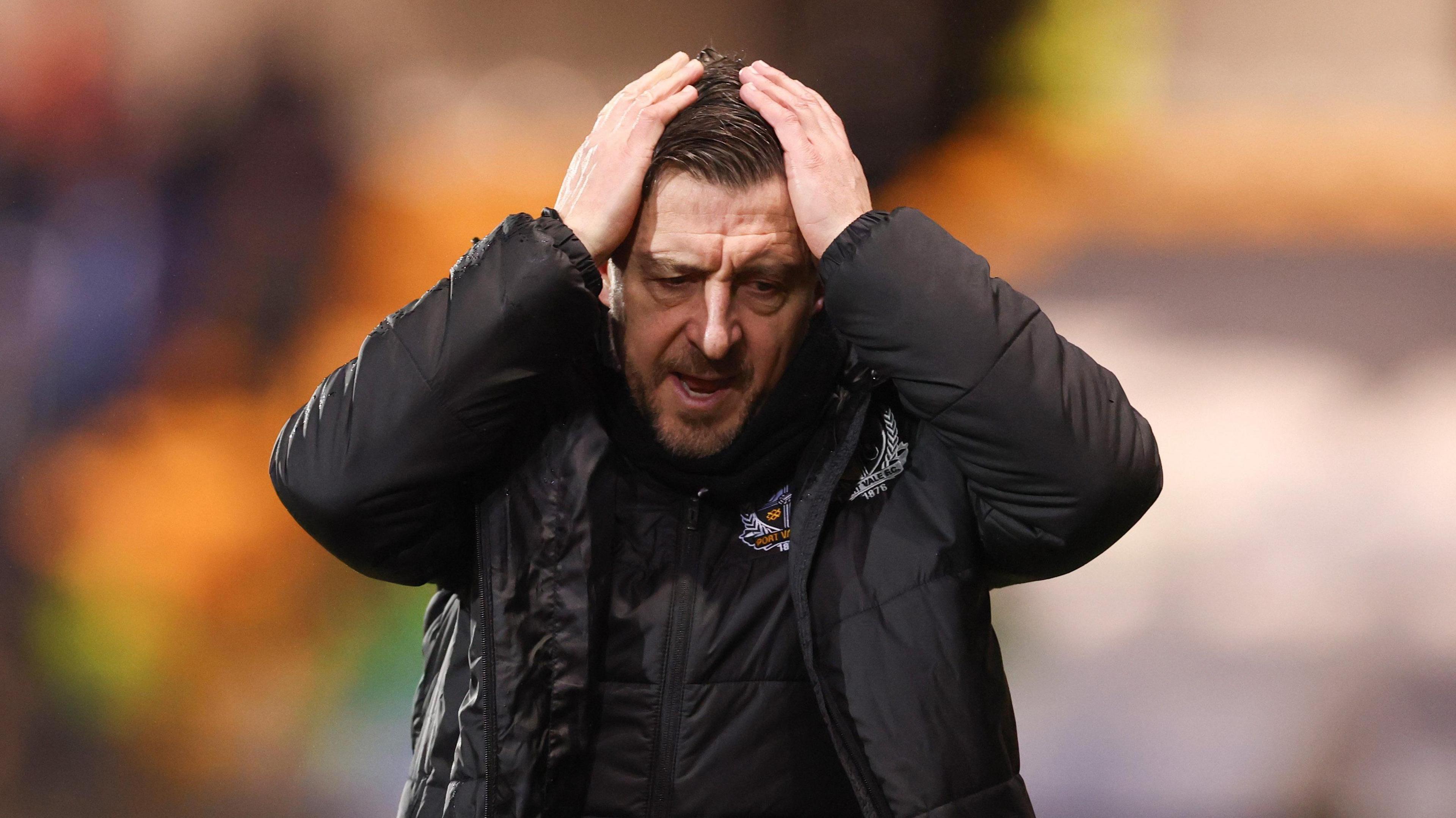 Port Vale manager Jon Brady puts his hands on his head in exasperation during the 4-0 defeat by Stockport