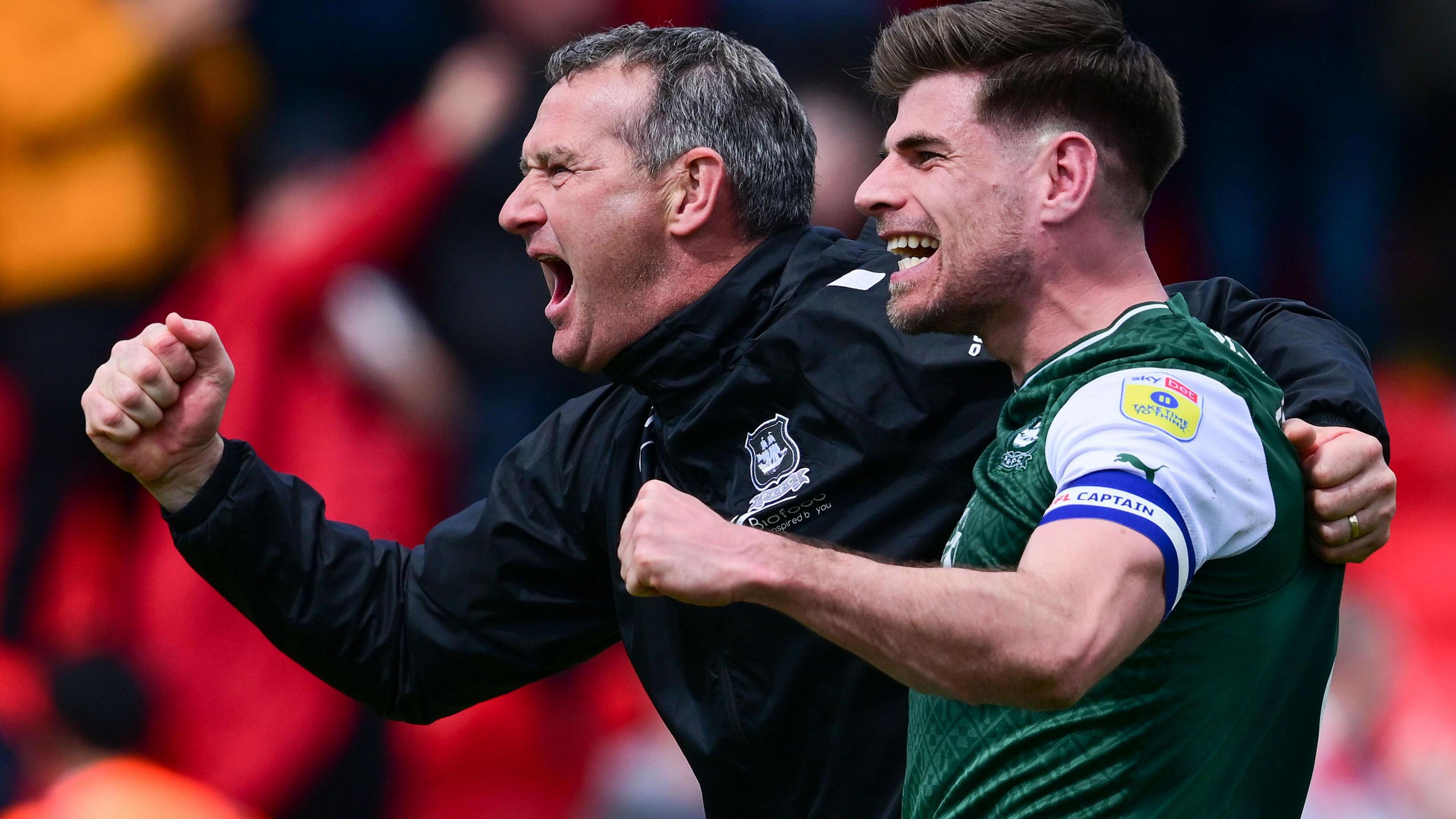 Argyle captain Joe Edwards and coach Kevin Nancekivell celebrate beating Exeter