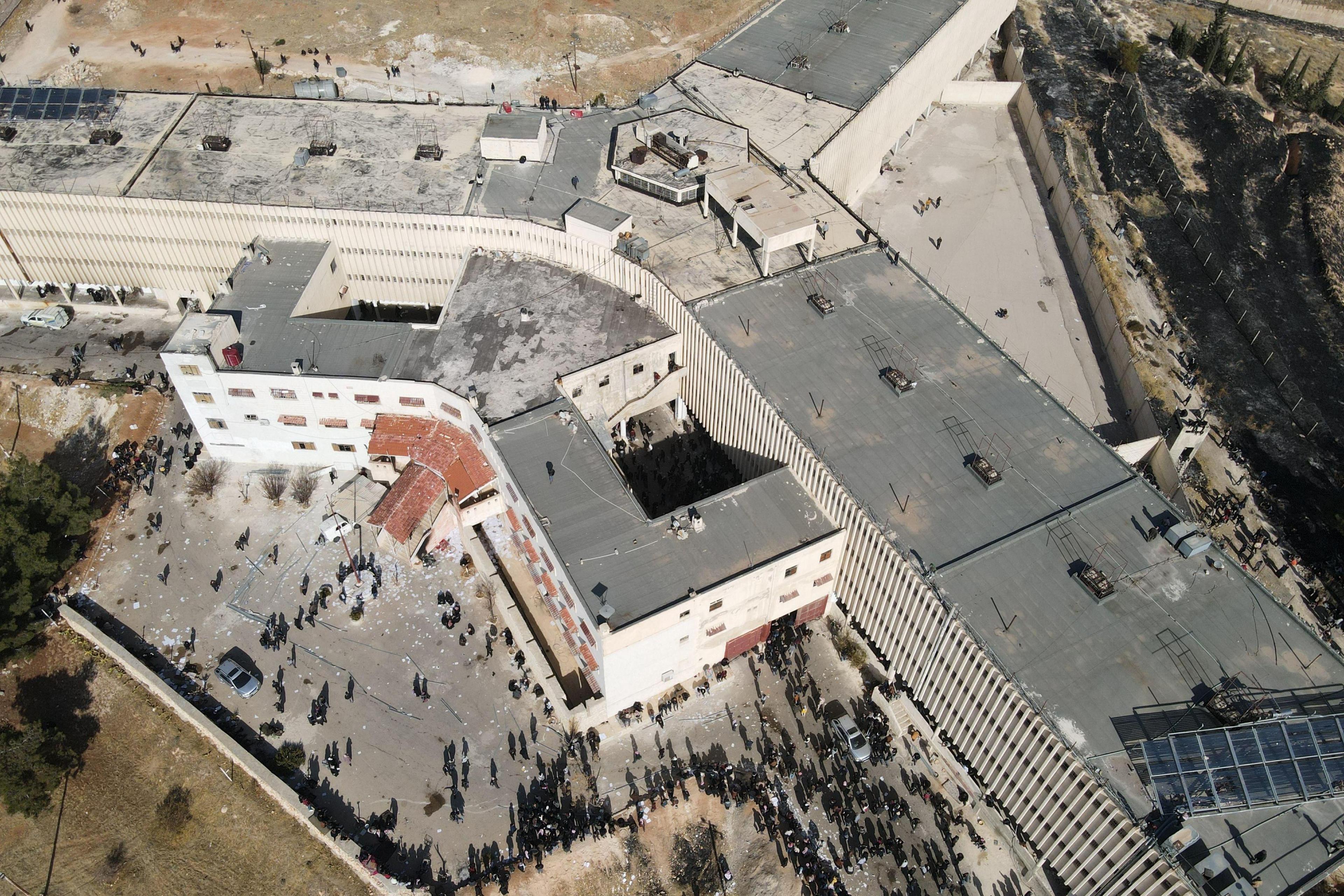 Rescuers and relatives of missing people gather at Saydnaya prison, north of Damascus, Syria (9 December 2024)