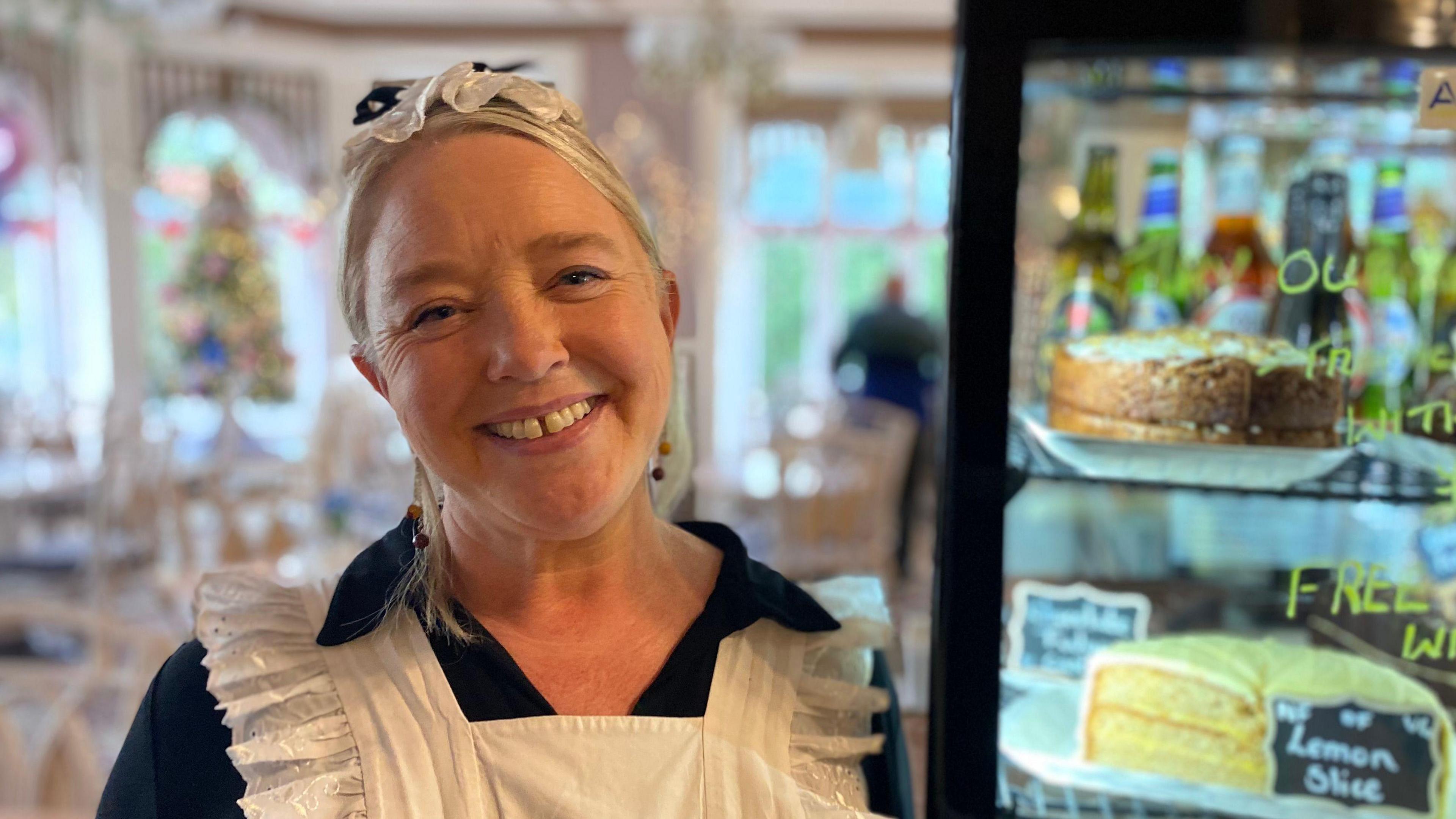 Ruth dressed in Victorian-style waitress apron