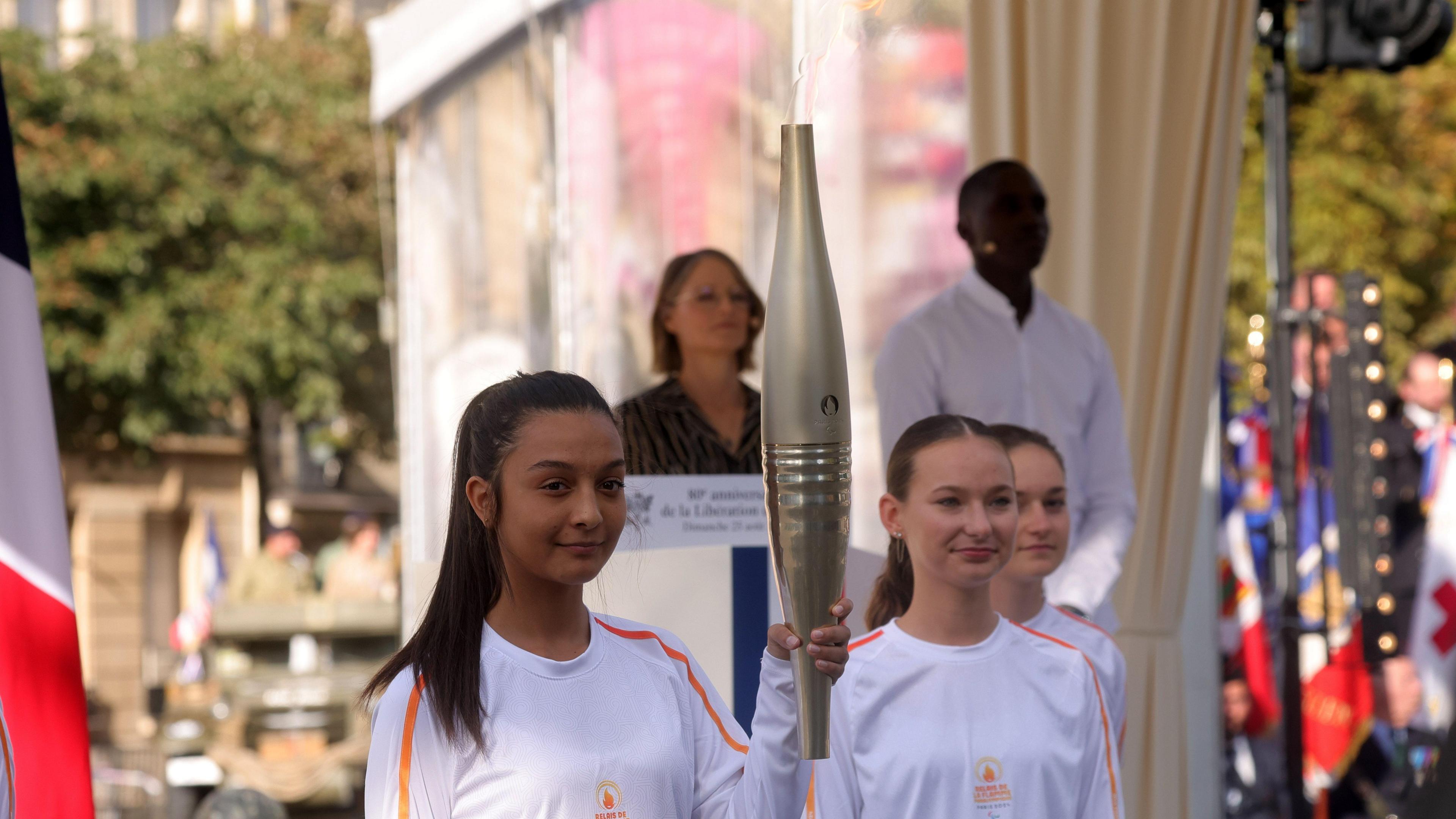 The torch for the upcoming Paris 2024 Paralympic Games is presented ahead of the opening ceremony on 28 August, after a ceremony commemorating the 80th anniversary of the Liberation of Paris next to the Denfert Rochereau Square in Paris, France, 25 August 2024.