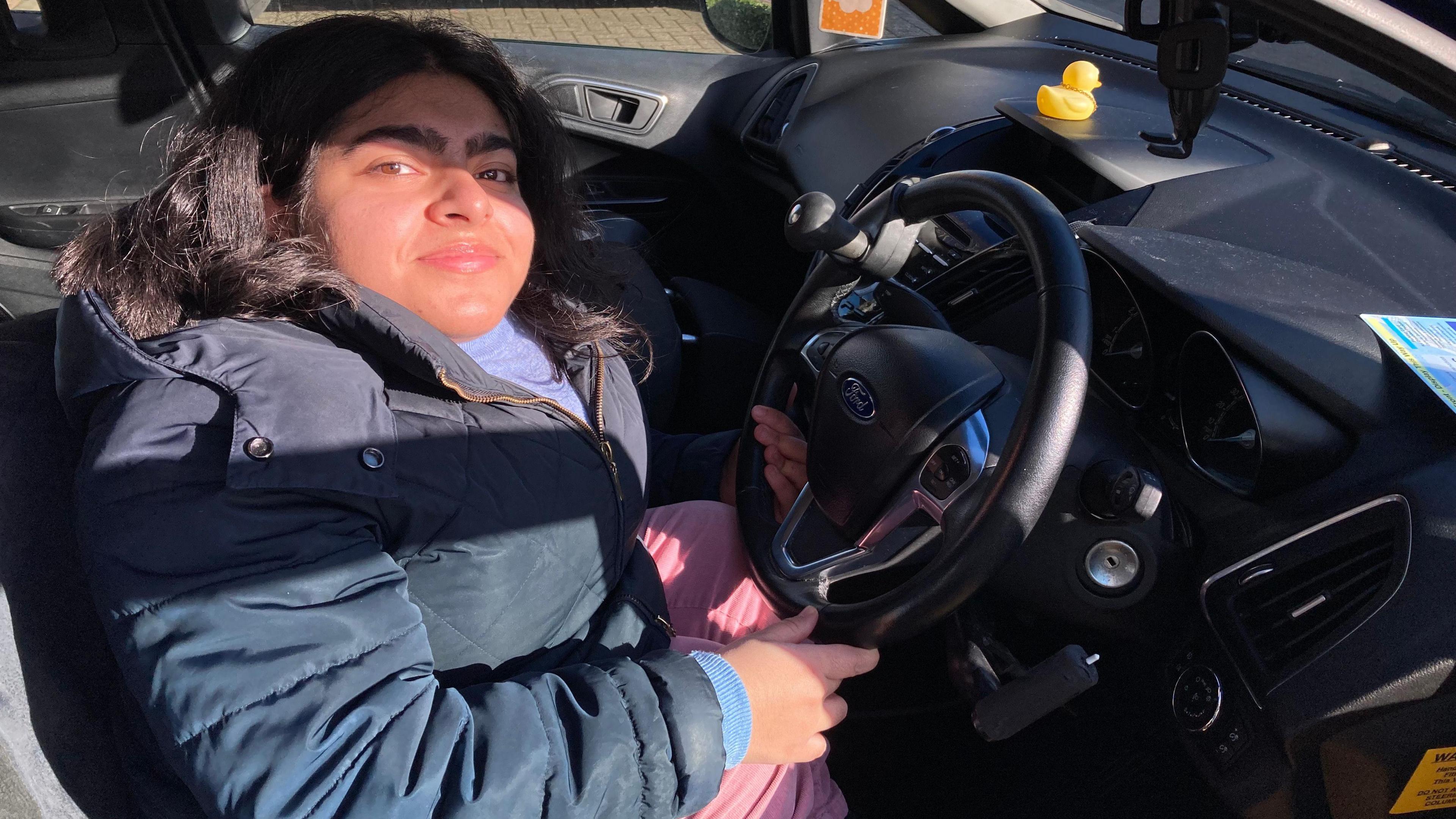 Iqra Saeed sitting in her car