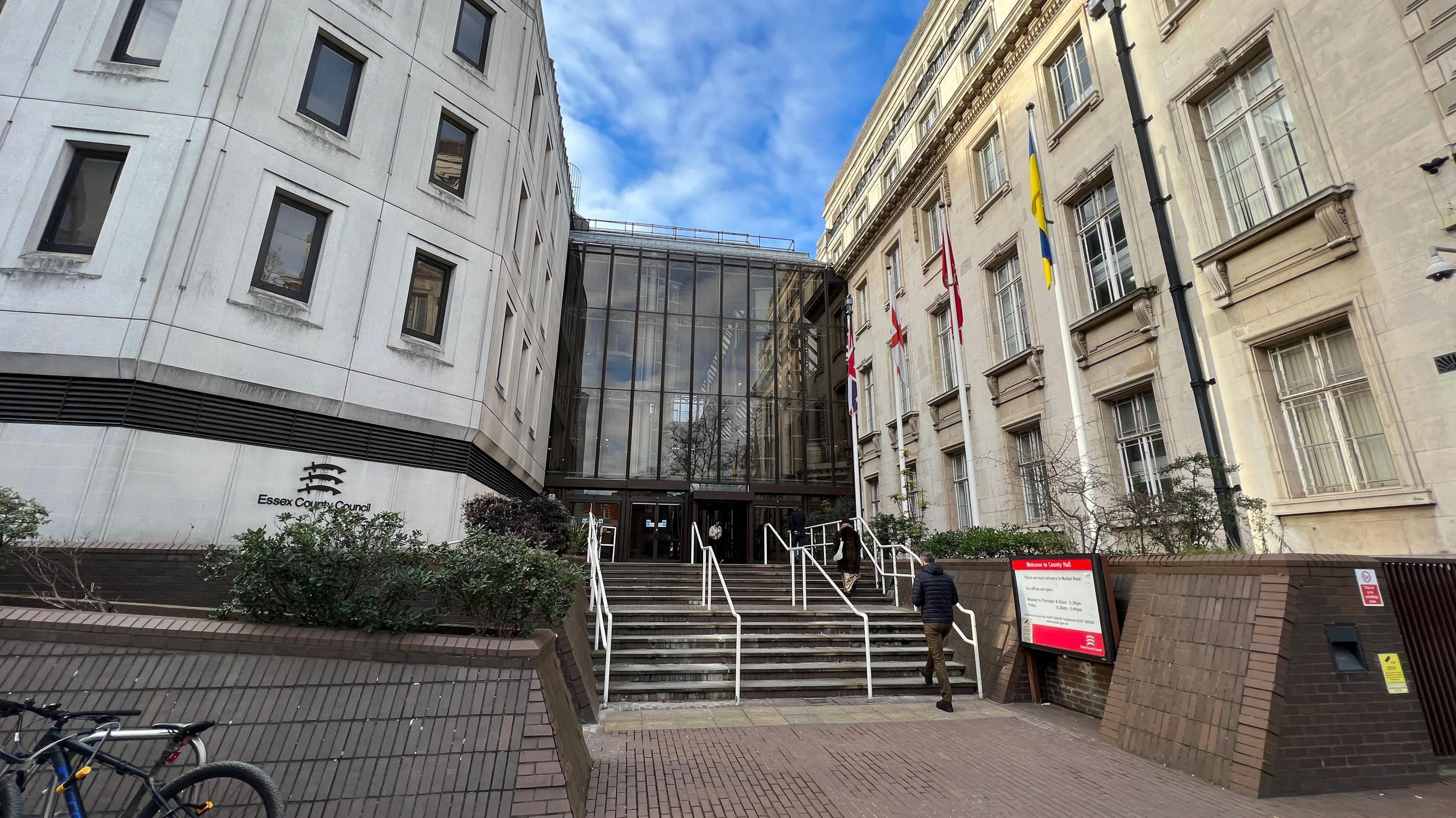 The outside of County Hall in Chelmsford, which has steps leading towards it. The building itself is cream in colour and is grand in its appearance.