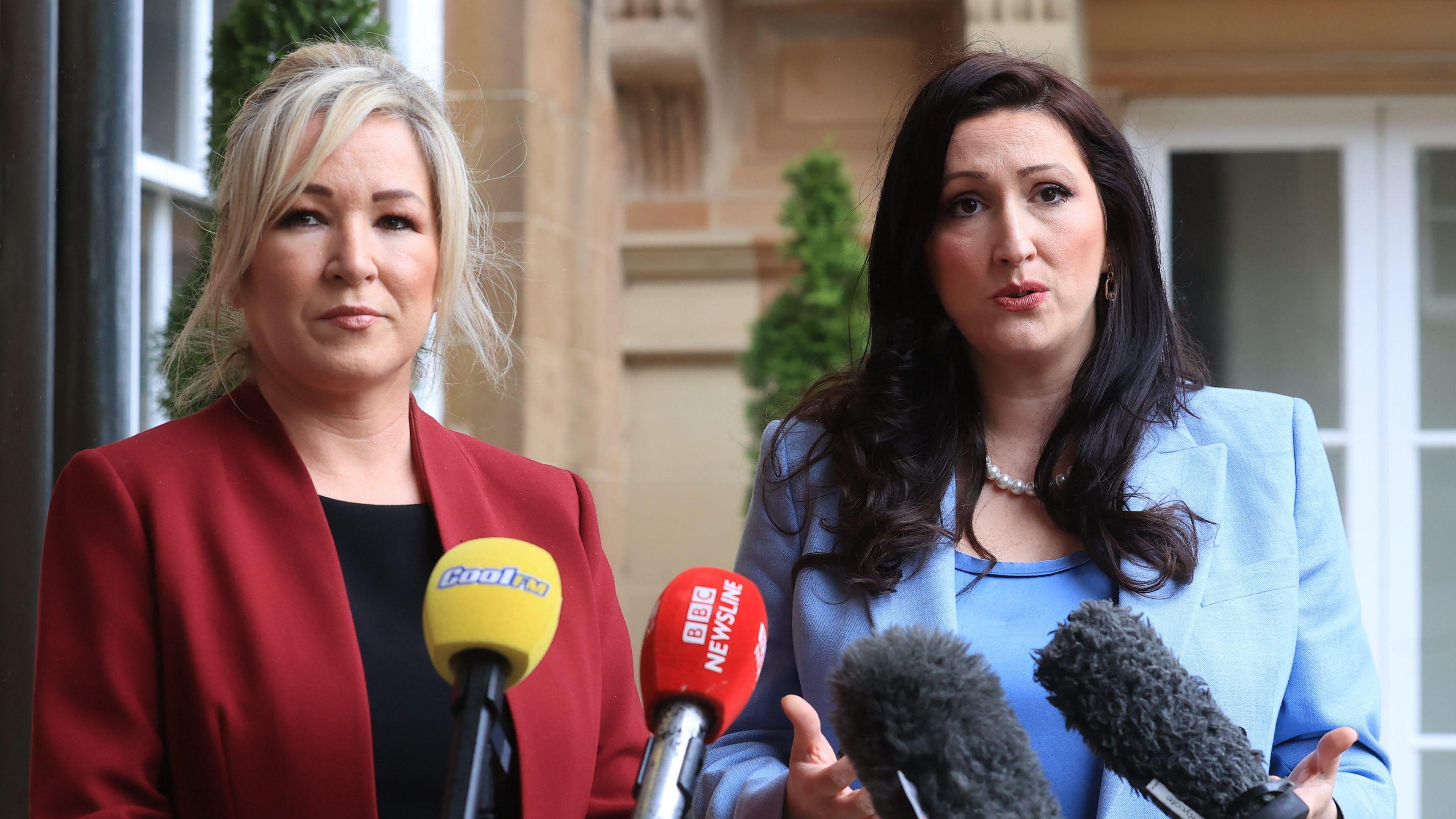 Michelle O'Neill and Emma Little-Pengelly speaking at a row of media mircophones
Michelle is in a red suit blazer and emma little pengelly is in a blue blazer and top 