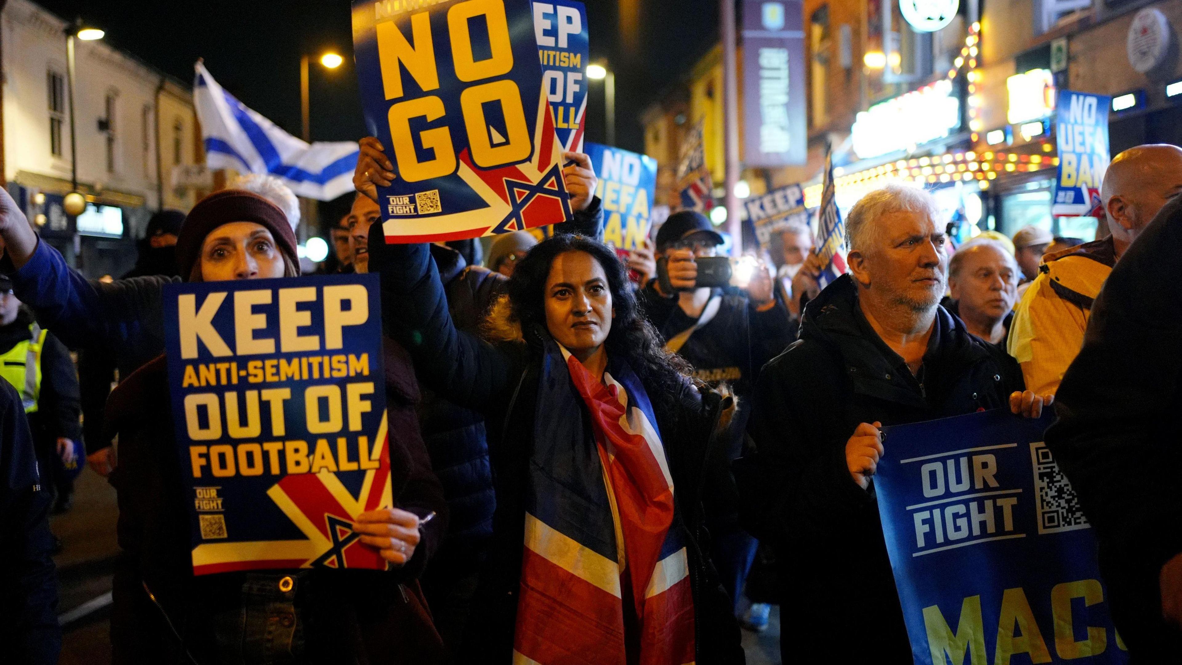 Pro Israel supporters are led to Villa Park, home of Aston Villa by police officers, before the UEFA Europa League match at Villa Park, Birmingham