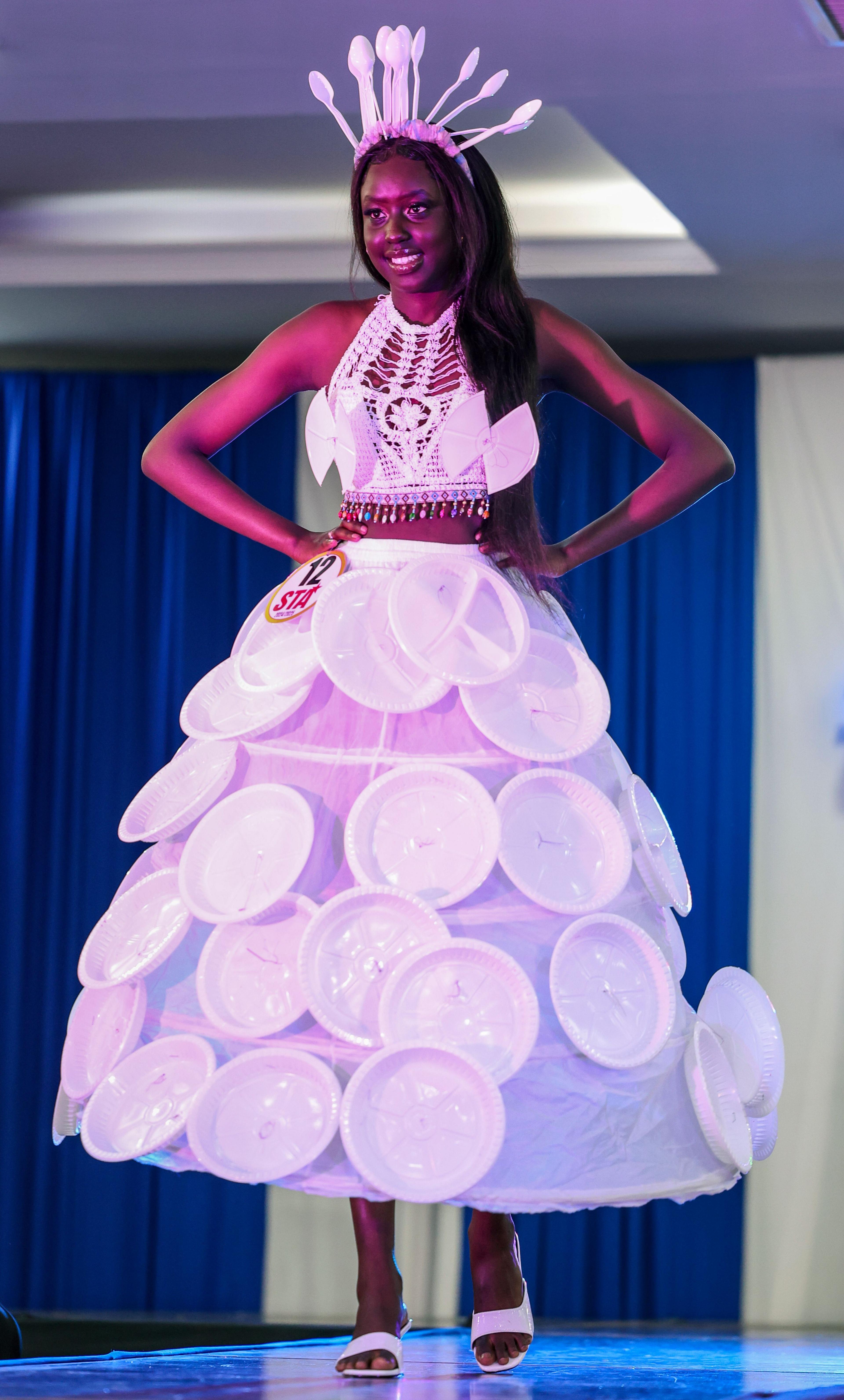 A model wearing a paper plate and cutlery inspired dress showcases her creation at the 11th edition of the South Sudan Theatre Awards 2024 (STA), in Nairobi, Kenya - Wednesday 18 December 2024.