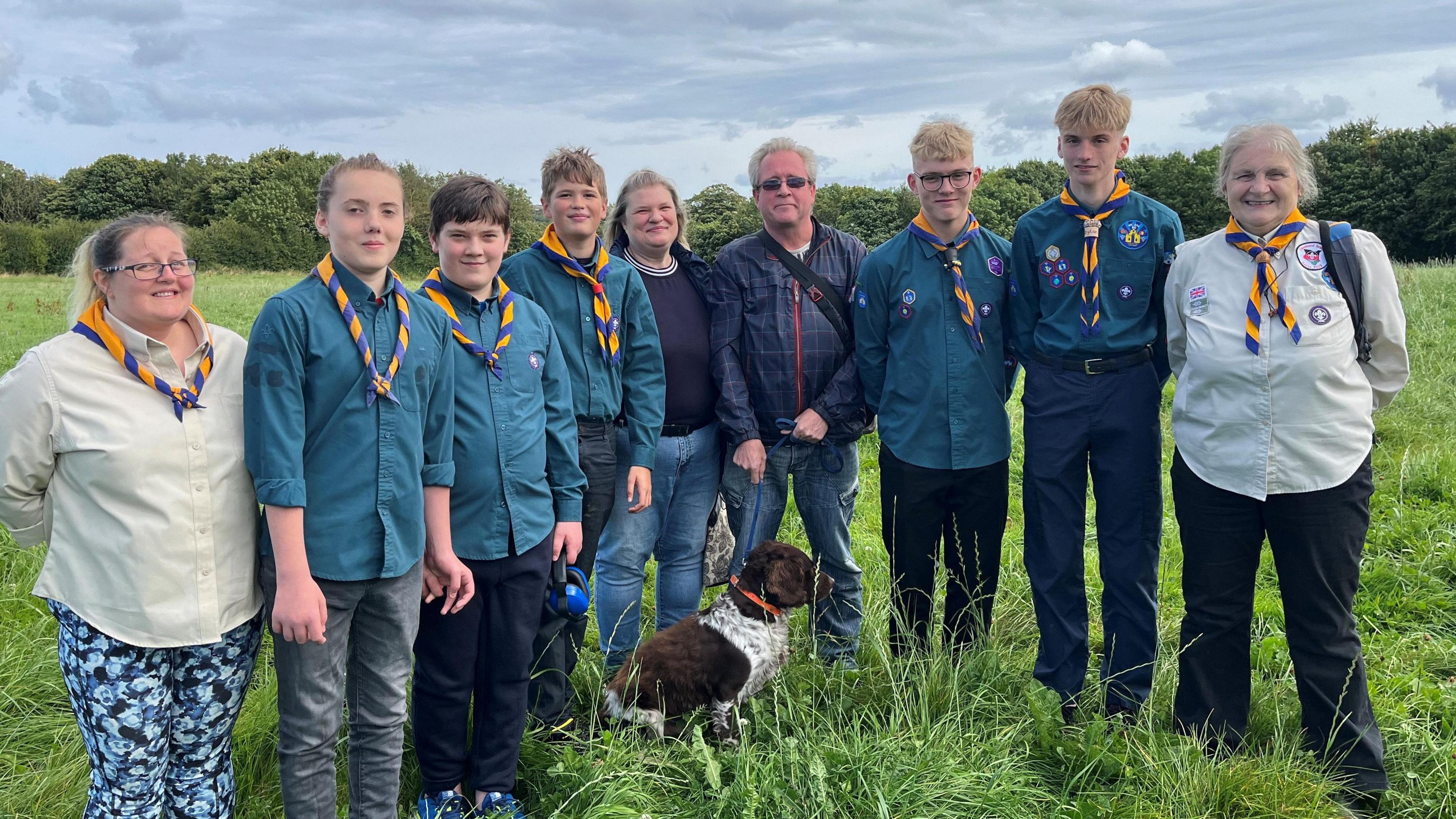 Five scouts from the First Loftus Scouts, with John Allinson and wife Joanne. Two female scout leaders are also pictured as well as a dog.