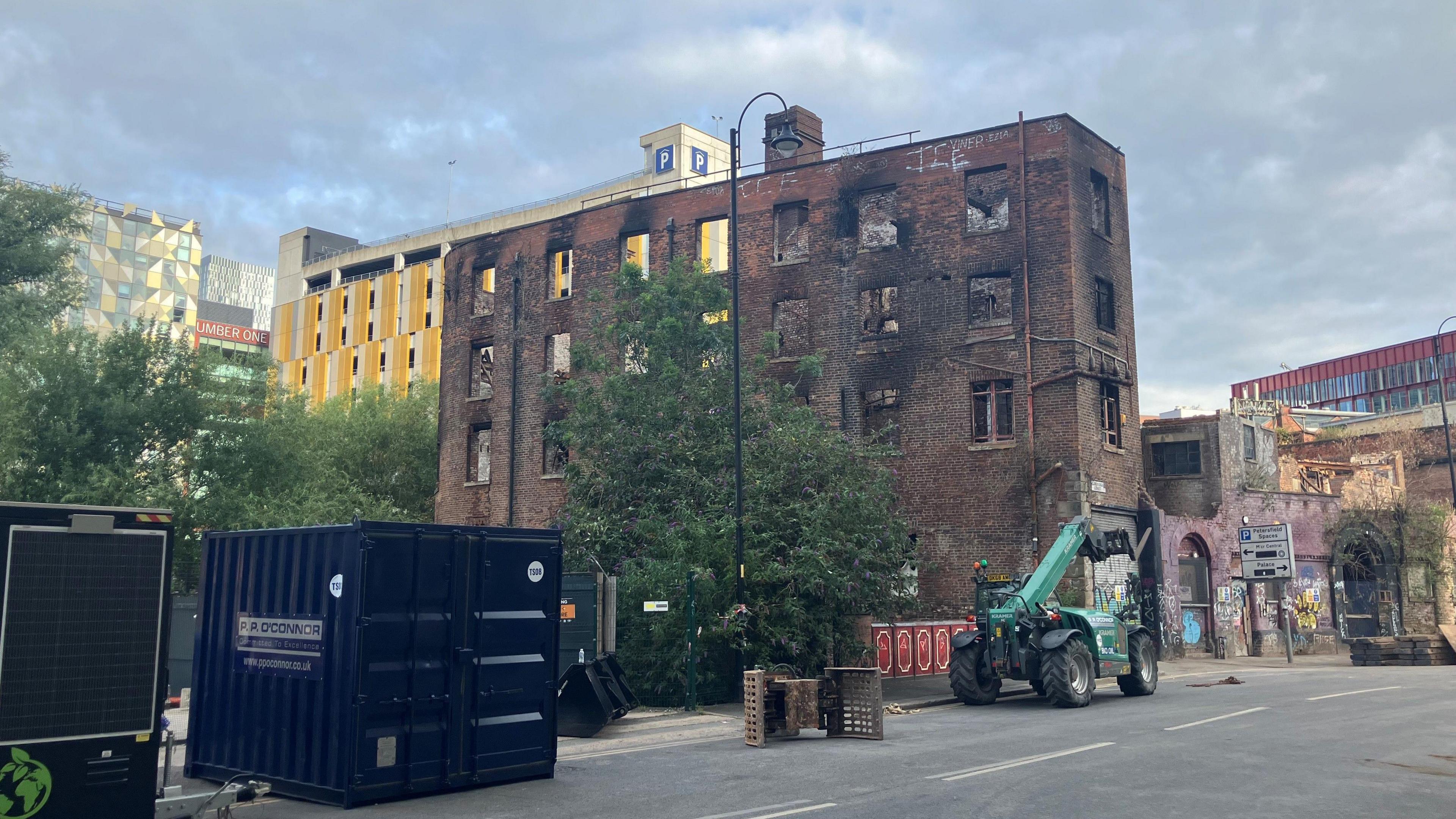 Photograph of the Hotspur Press building in Manchester city centre. It shows the damage - including blackened windows - caused by the recent fire.