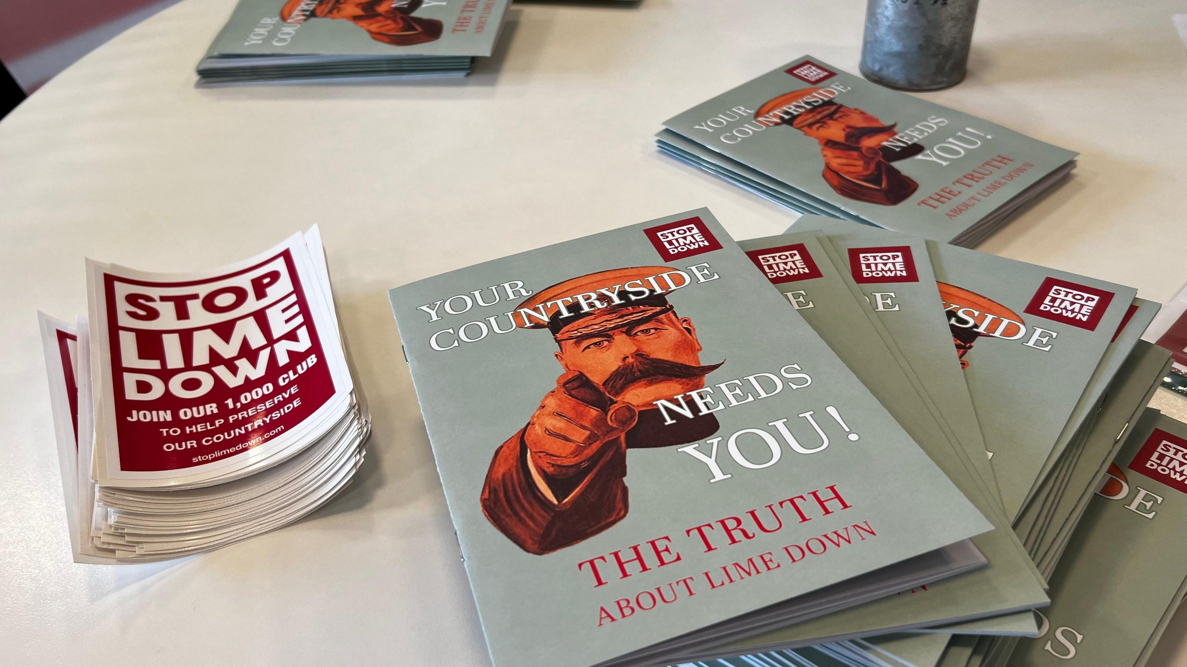 Leaflets opposing the Lime Down campaign lie on a table. One is titled '' Your Countryside needs you?" and features a World War One style general pointing his finger.