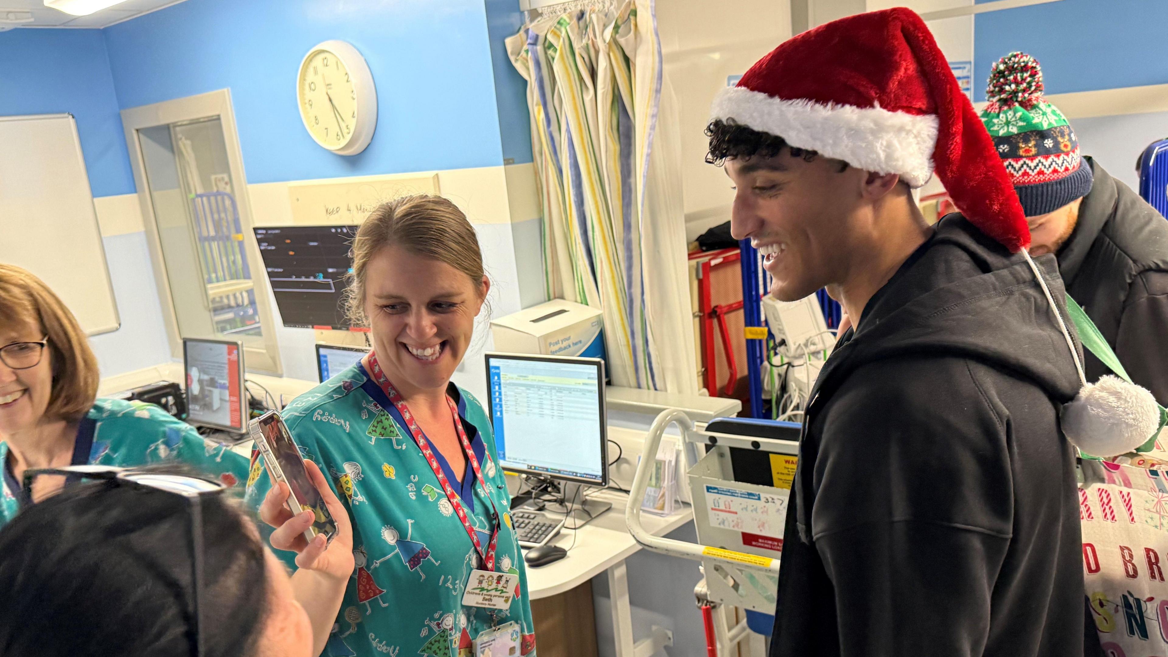 Norwich City player Ben Chrisene chatting to hospital staff