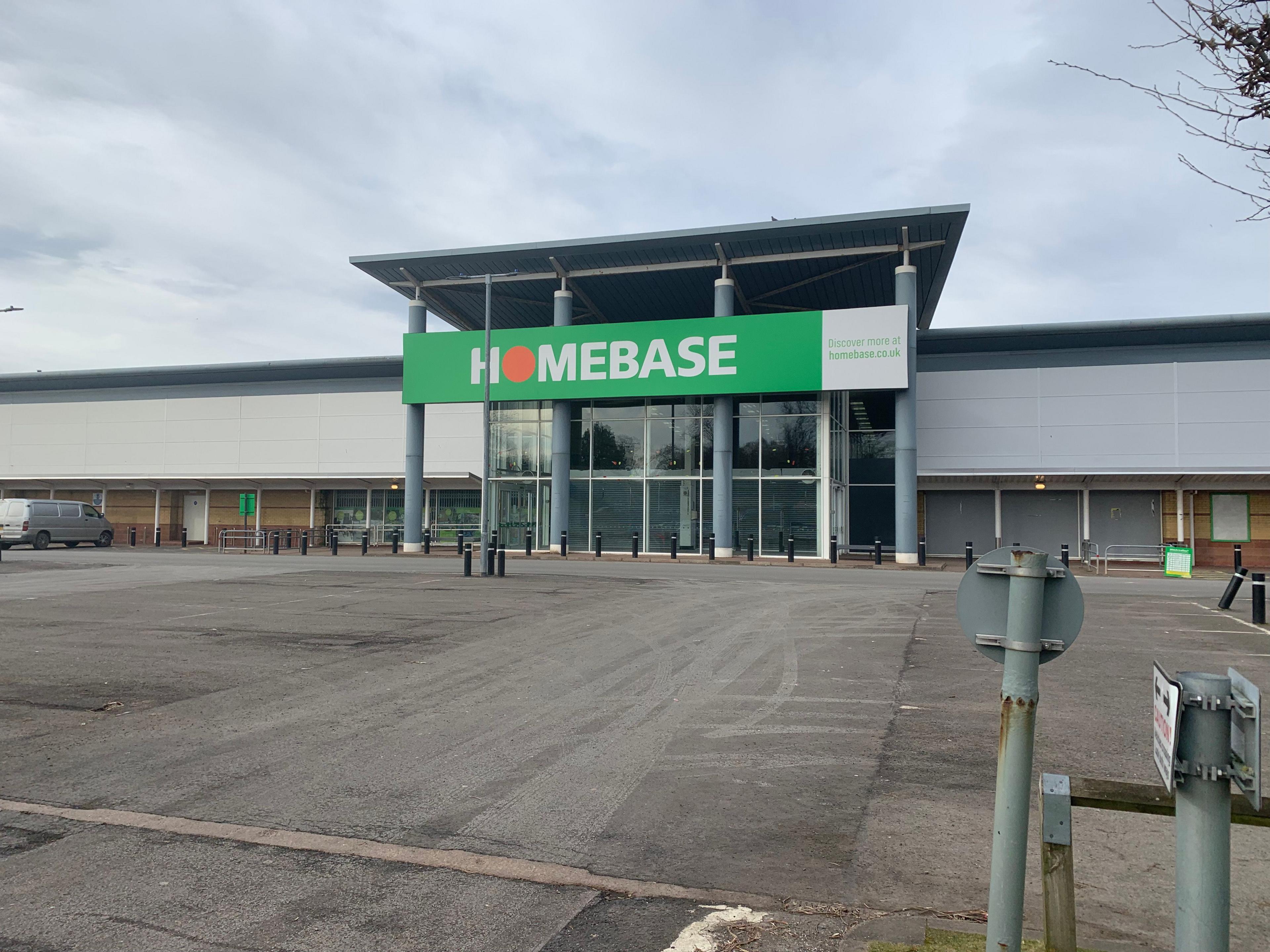 A grey-fronted former Homebase store with an empty car park in front of it