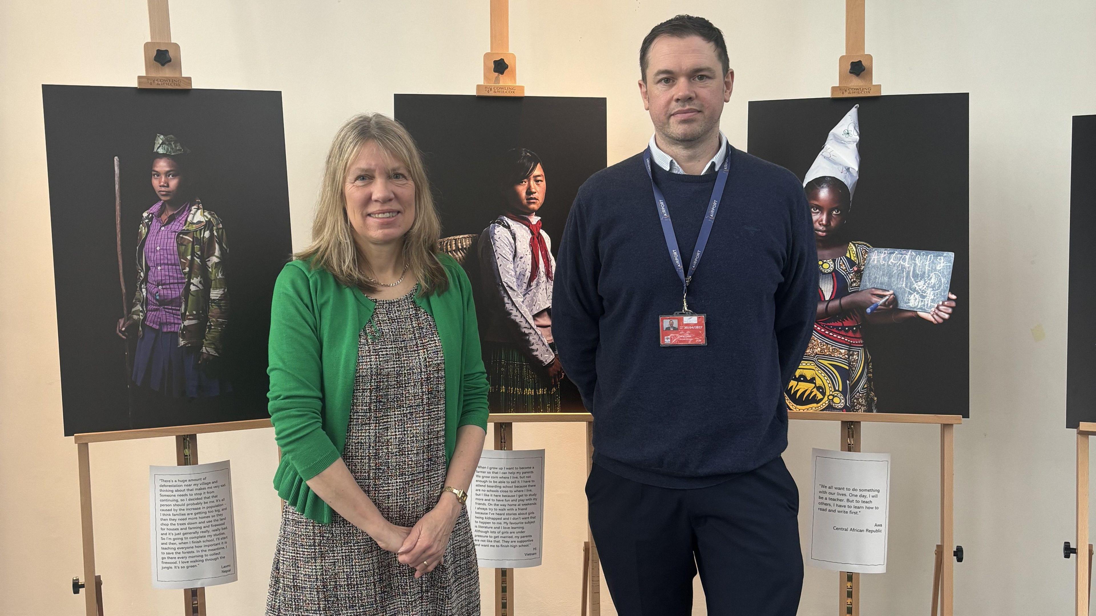 Wendy Shimmin from the One World Centre with airport director Gary Cobb  by some of the images