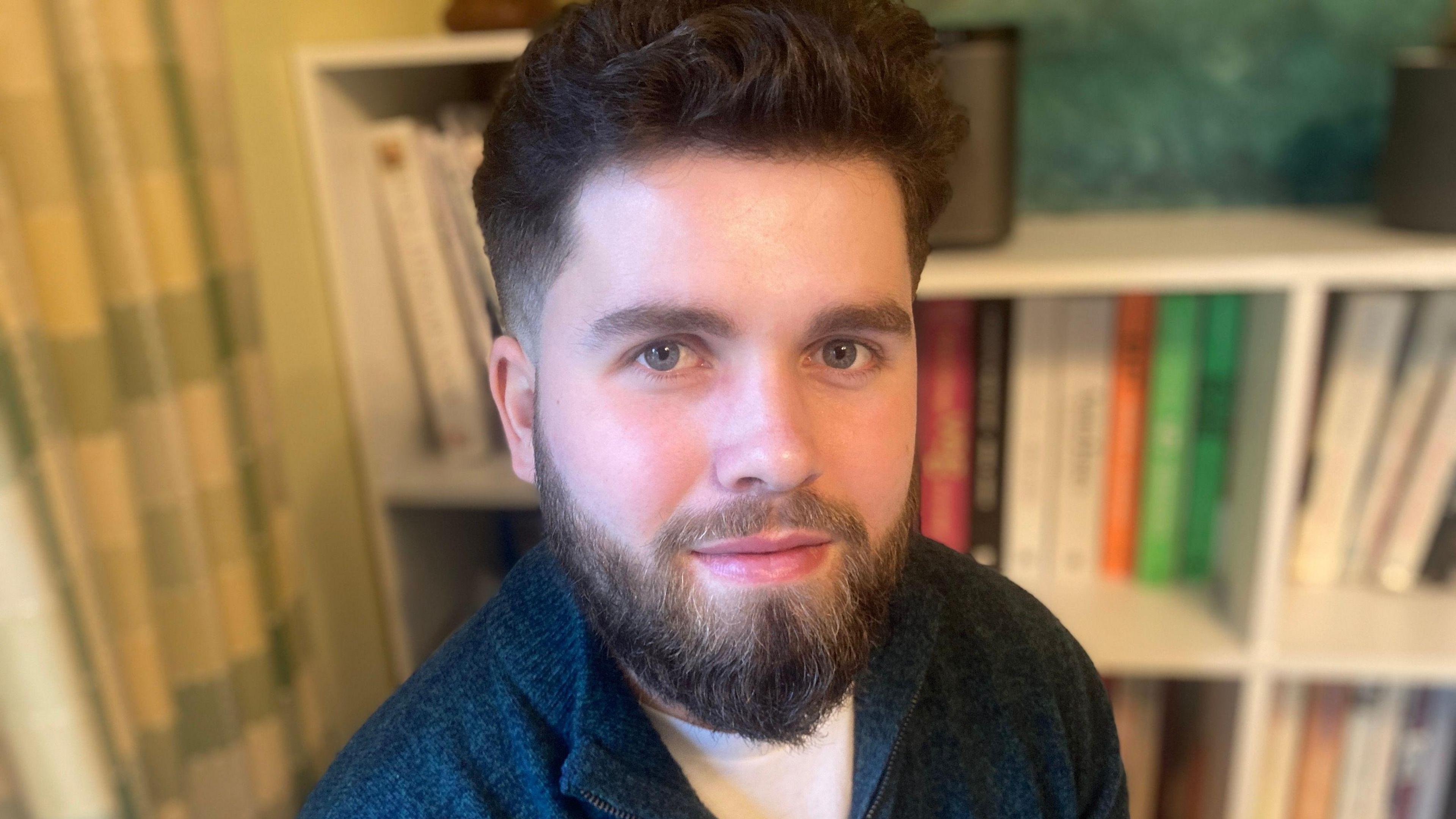 Rory Wilson - a man with brown hair and beard and a moustache. He is wearing a blue fleece and looking into the camera.