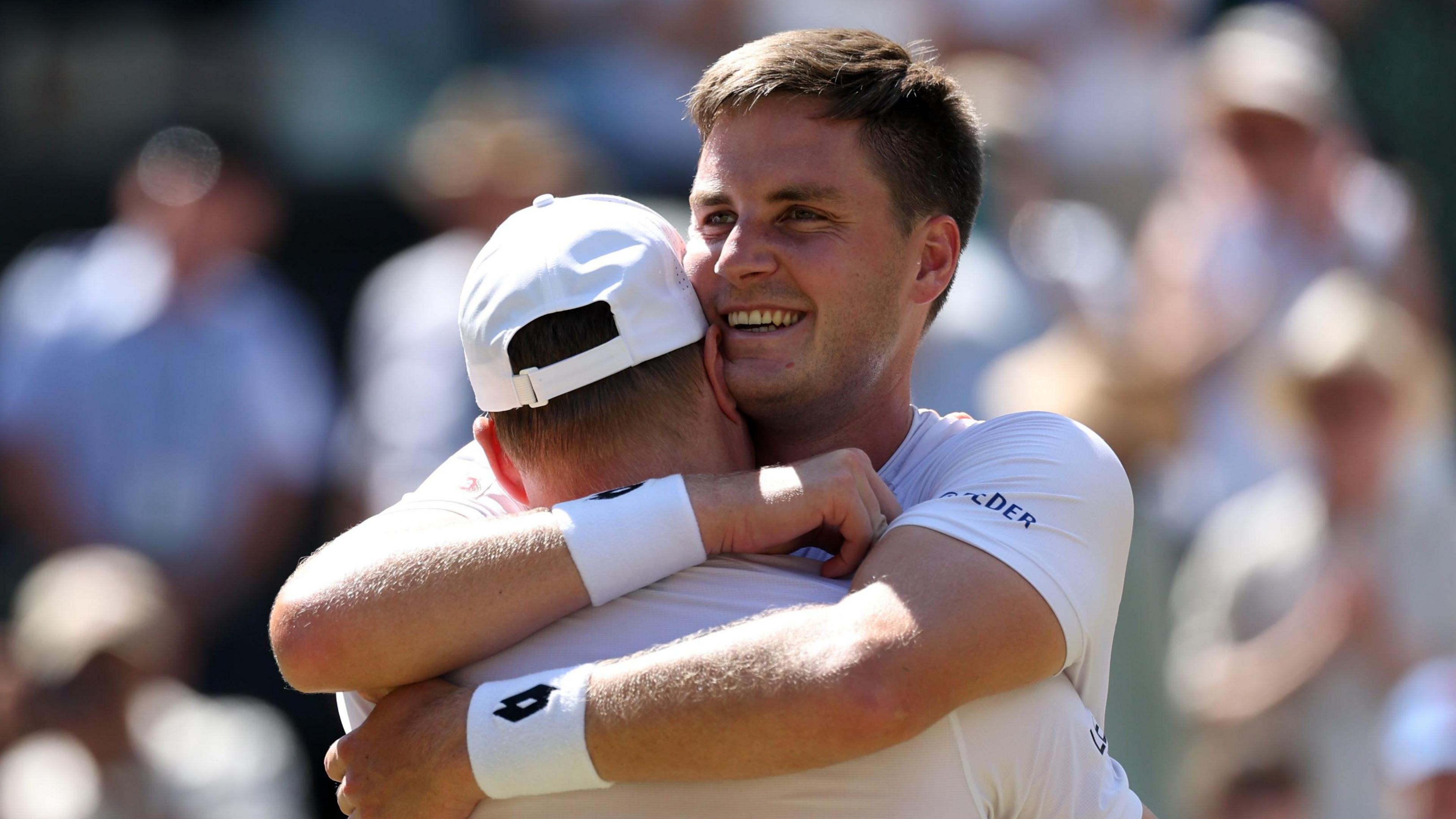 Henry Patten embraces team-mate Harri Heliovaara after winning the Wimbledon men's doubles title