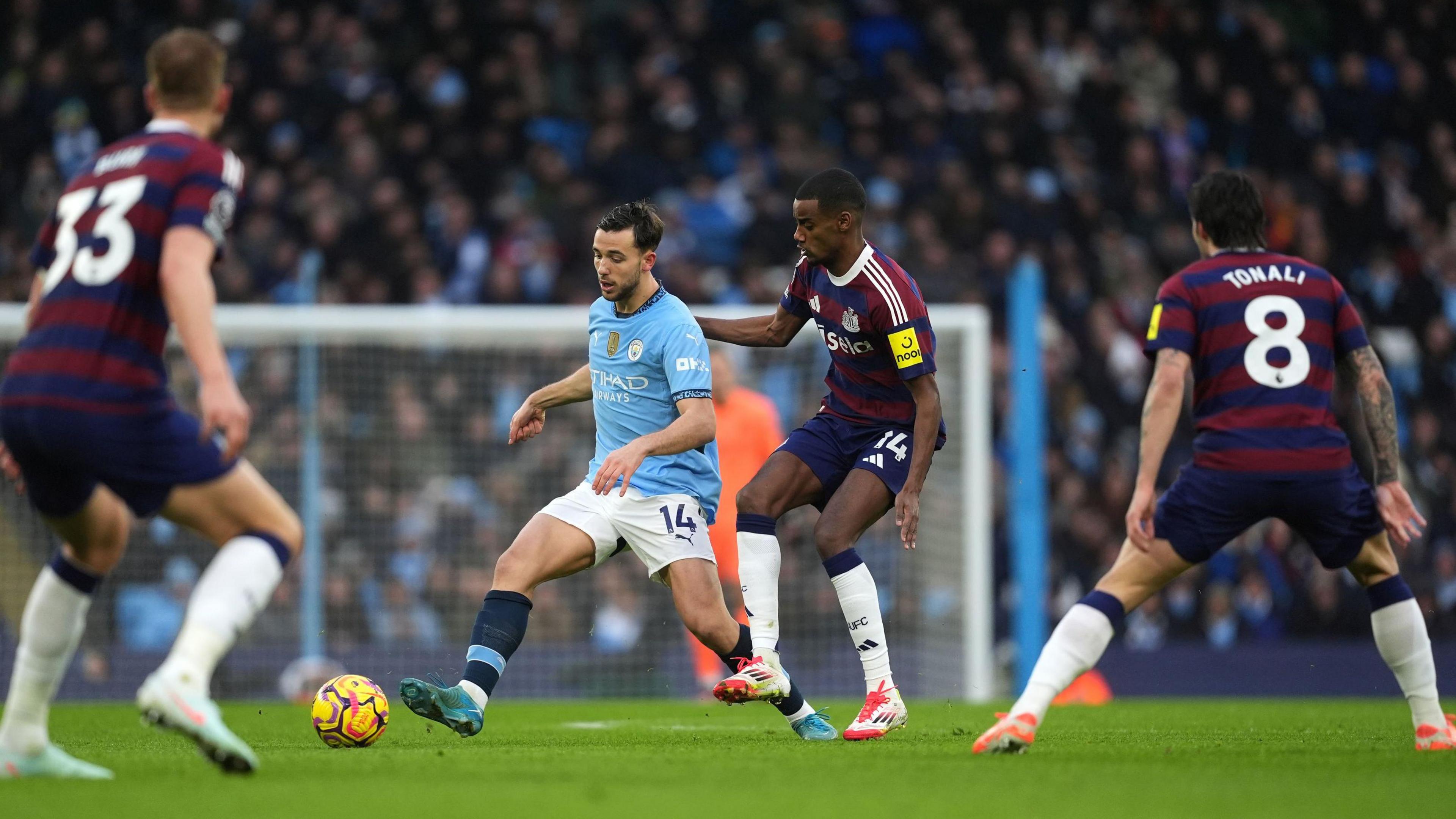 Nico Gonzalez on the ball, surrounded by Newcastle players during their Premier League game on Saturday