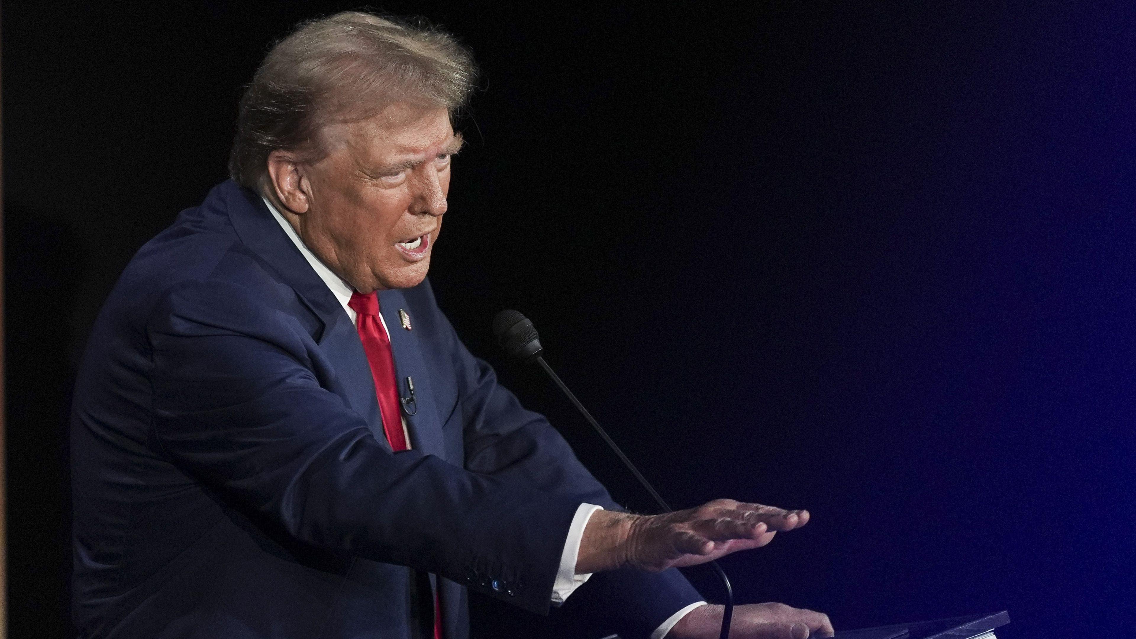 Presidential candidate Donald Trump holds his hand in front of him as he makes a point 