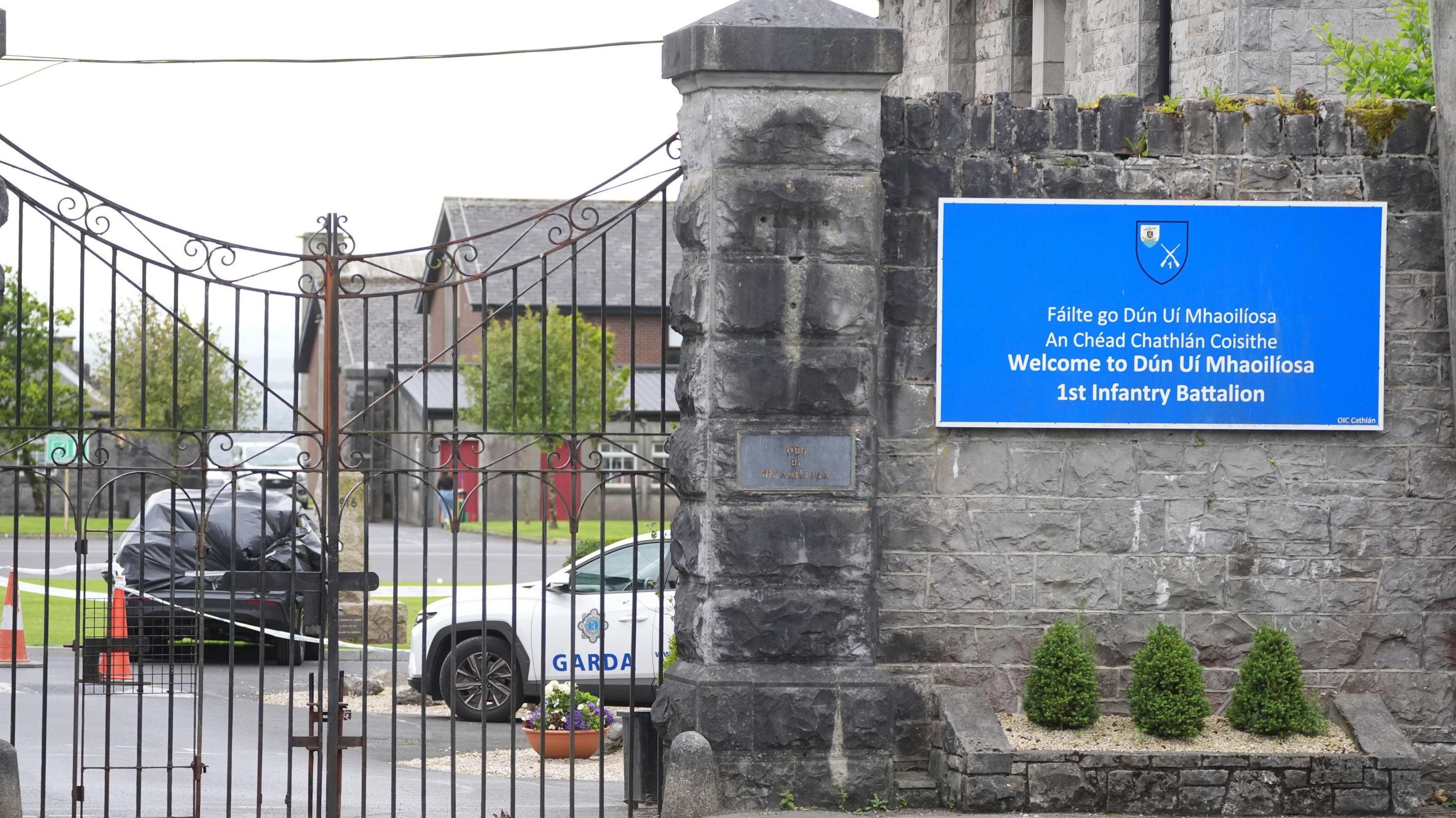 A car wrapped in black plastic and a garda car at the scene at Renmore Barracks in County Galway, after an army chaplain was stabbed