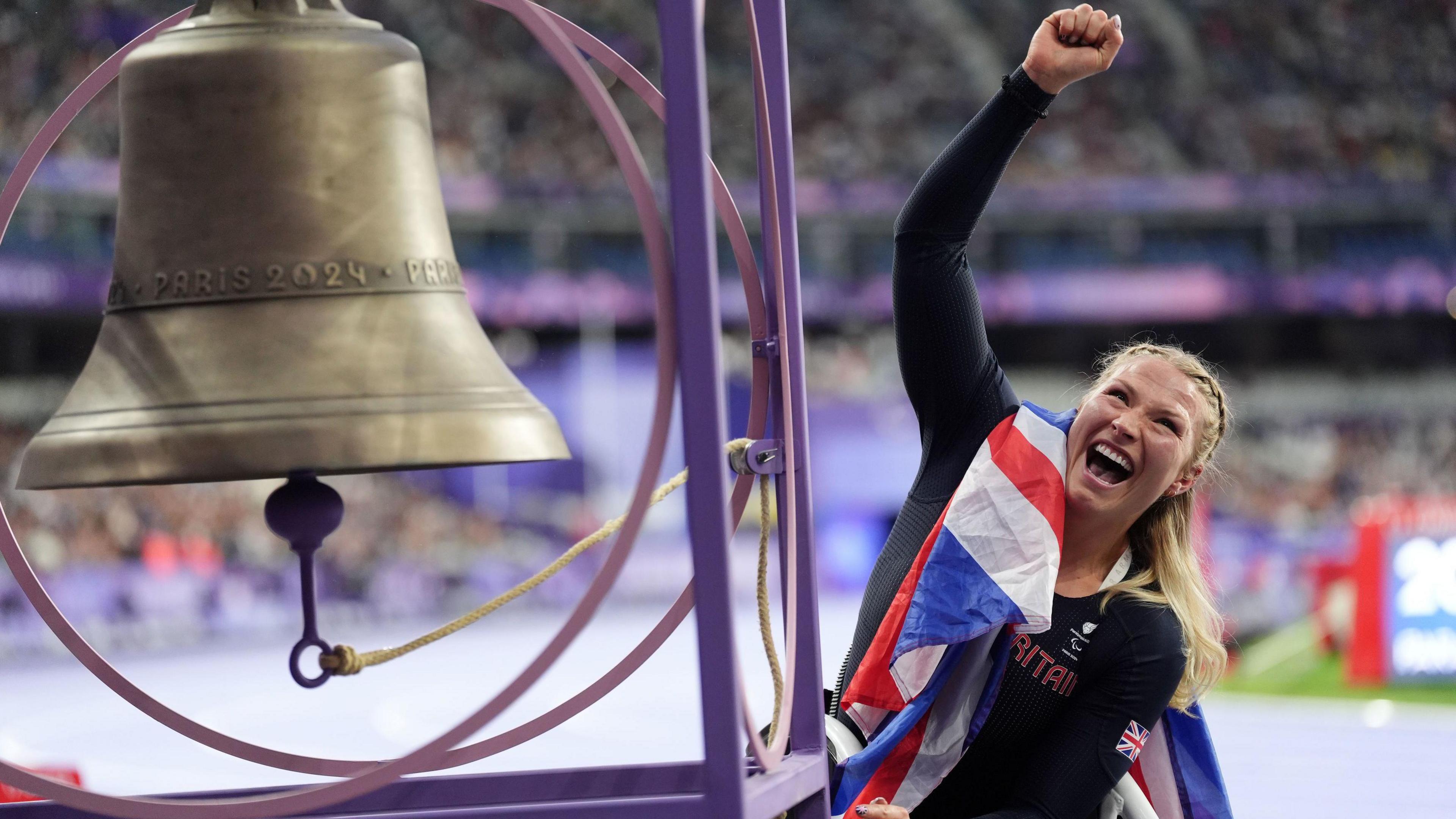 Sammi Kinghorn rings the bell at Stade de France after winning her first Paralympic gold