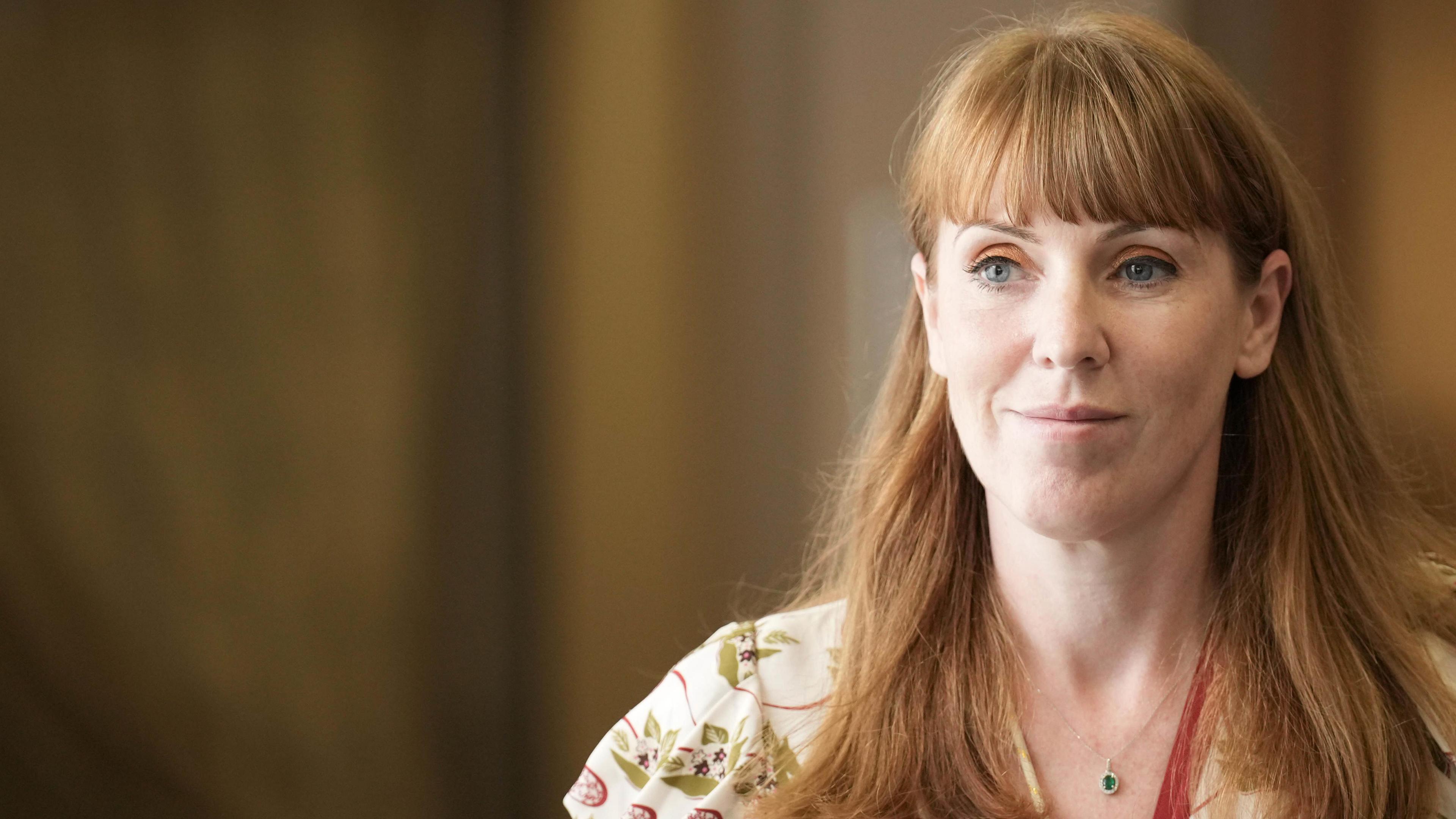 Deputy Prime Minister Angela Rayner with her hair down and wearing a cream patterned dress