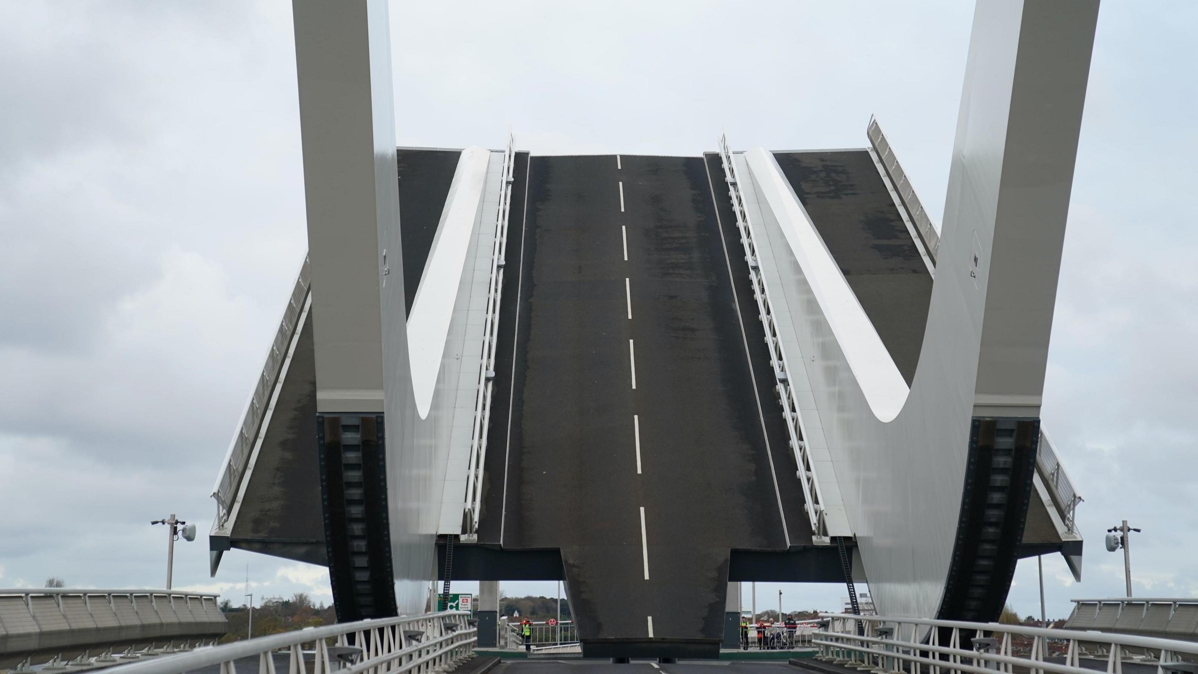 Another view of the bridge as it opens. Part of it can be seen at an angle in the air as it allows boats to sail through.