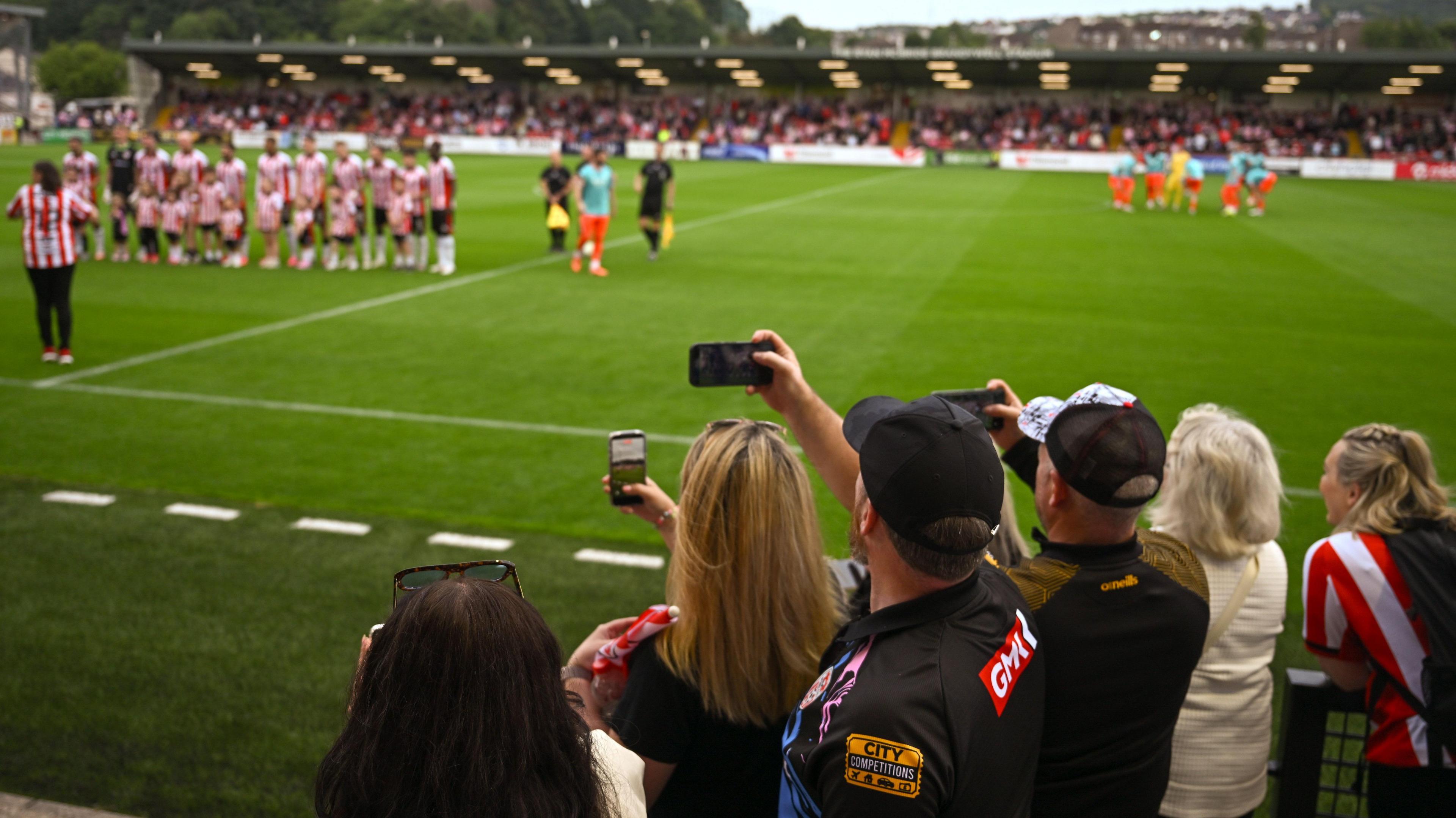 Fans take pitcures at the Brandywell