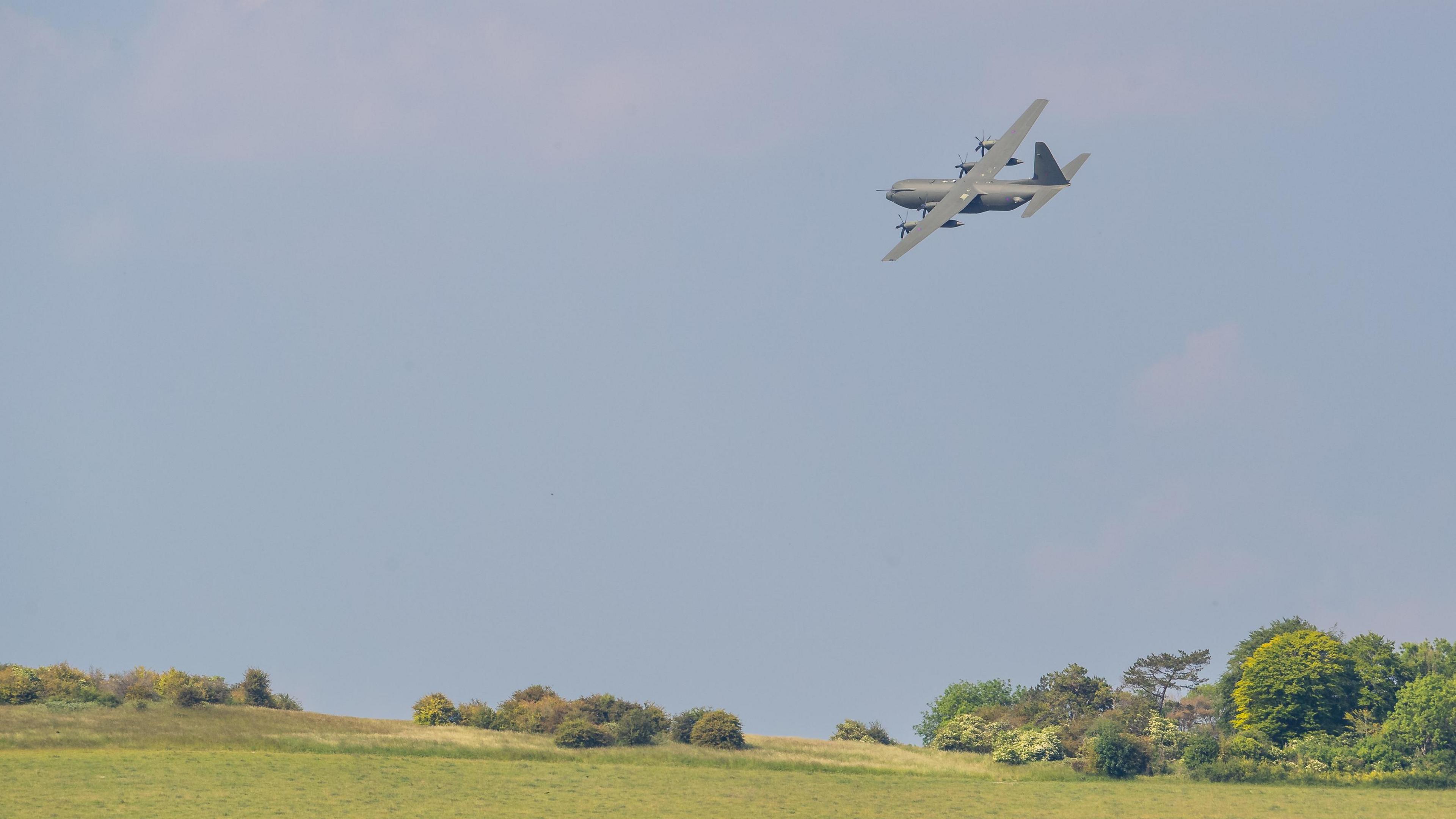 Hercules aircraft flying over fields at Boscombe Down