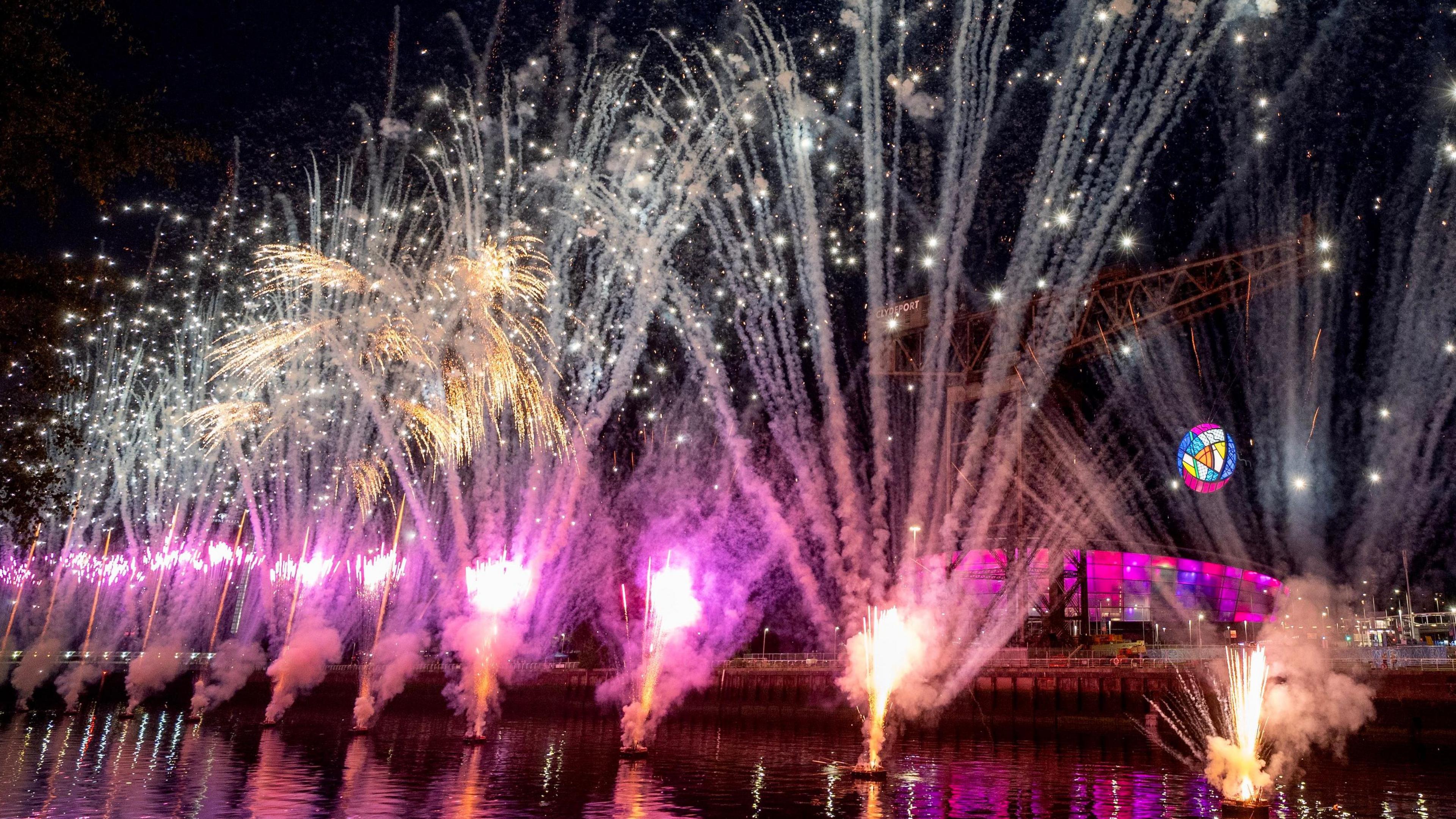 purple and gold fireworks over the river clyde