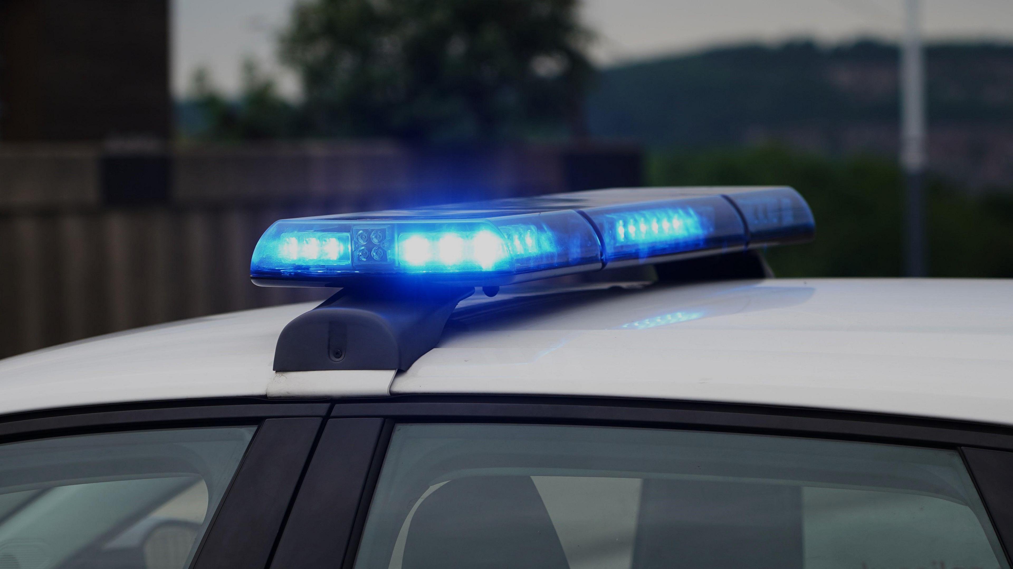 A set of blue lights on the white roof of a police car